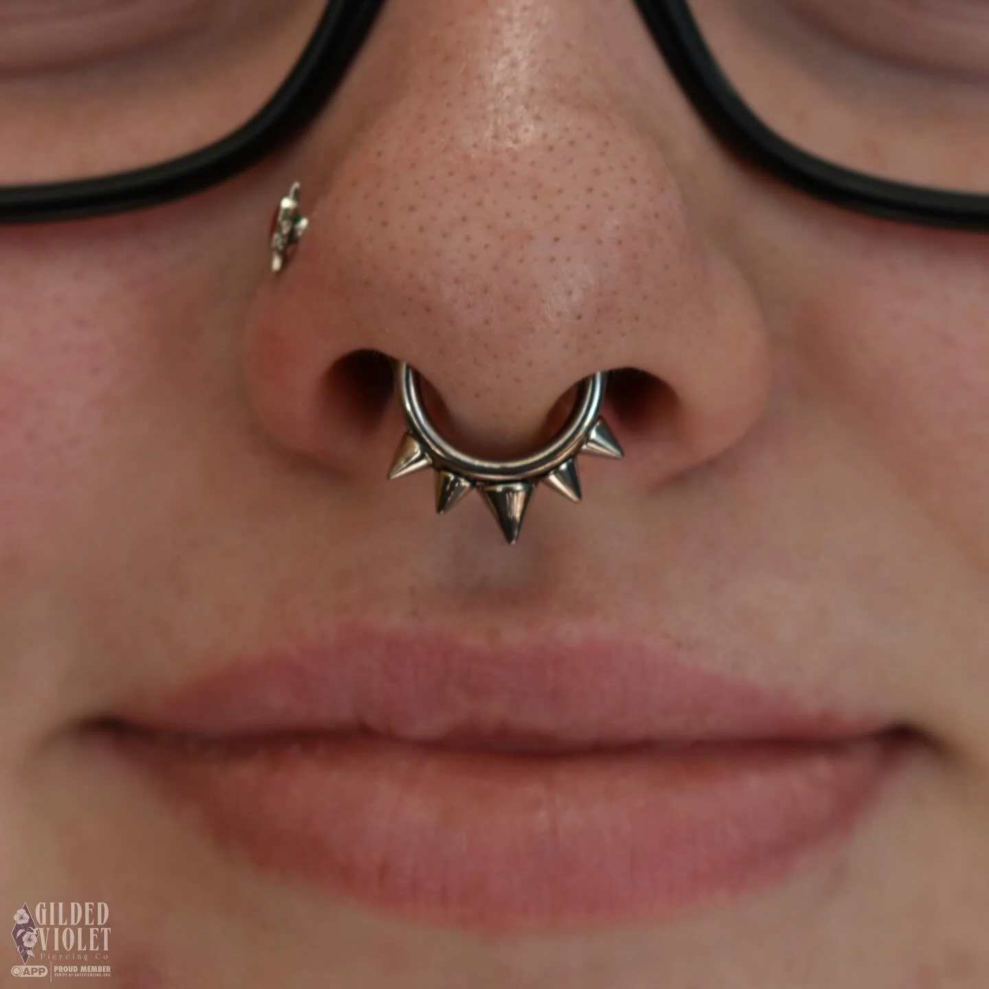 I love septum piercings- they're so versatile and fun, and they suit everyone! This client chose a spiked titanium hinge ring for their fresh septum, and it couldn't be more tuff 🗡️ 
.
.
.
#gildedvioletpiercing #jeannettepa #appmember #septumpiercin