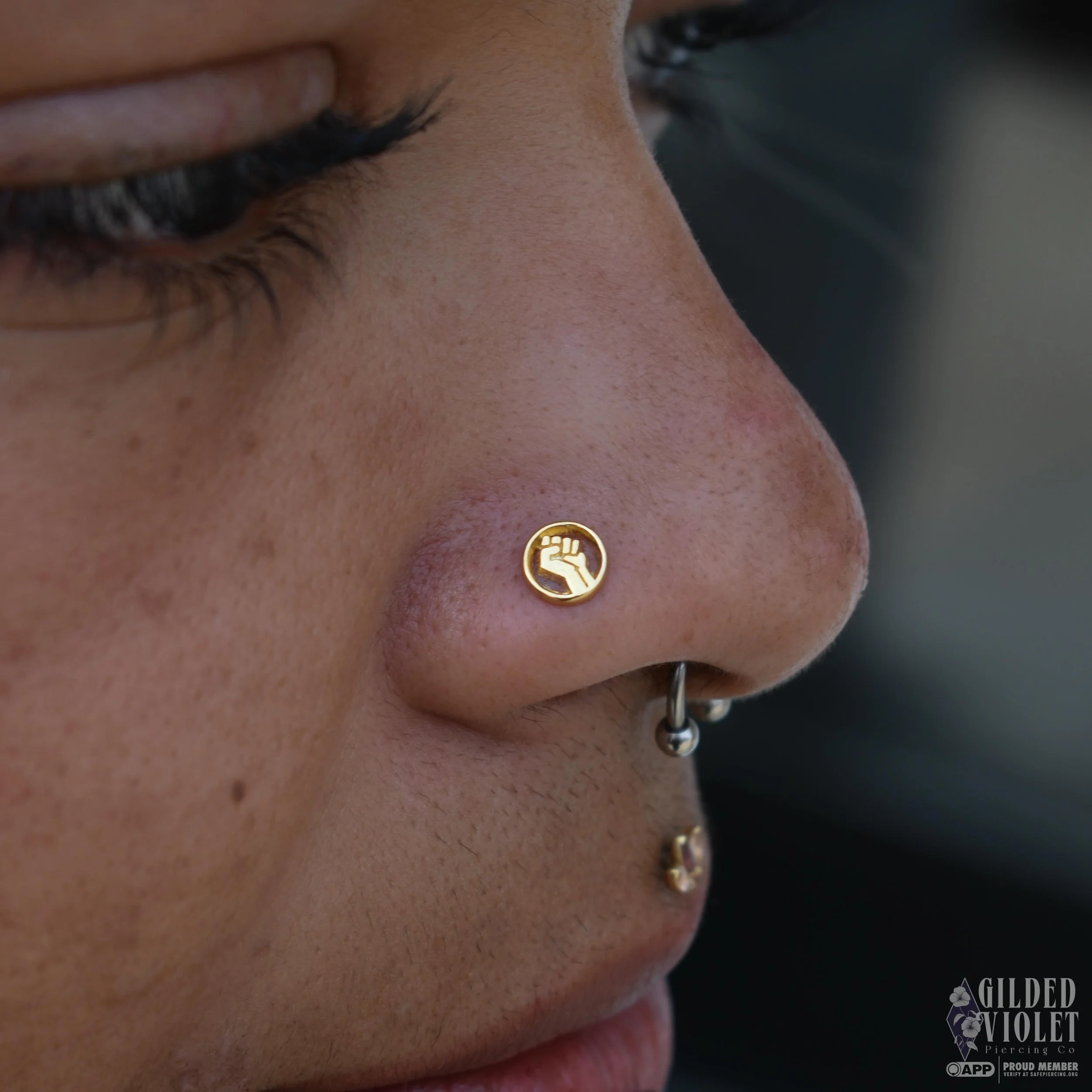 Fresh nostril for Guan&iacute; ✨ wearing a beautiful reminder to continue to resist and protect one another. 🖤
Swipe ➡️ for a bonus pic of their healed philtrum 
.
.
#gildedvioletpiercing #nostrilpiercing #resist #jeannettepa #appmember