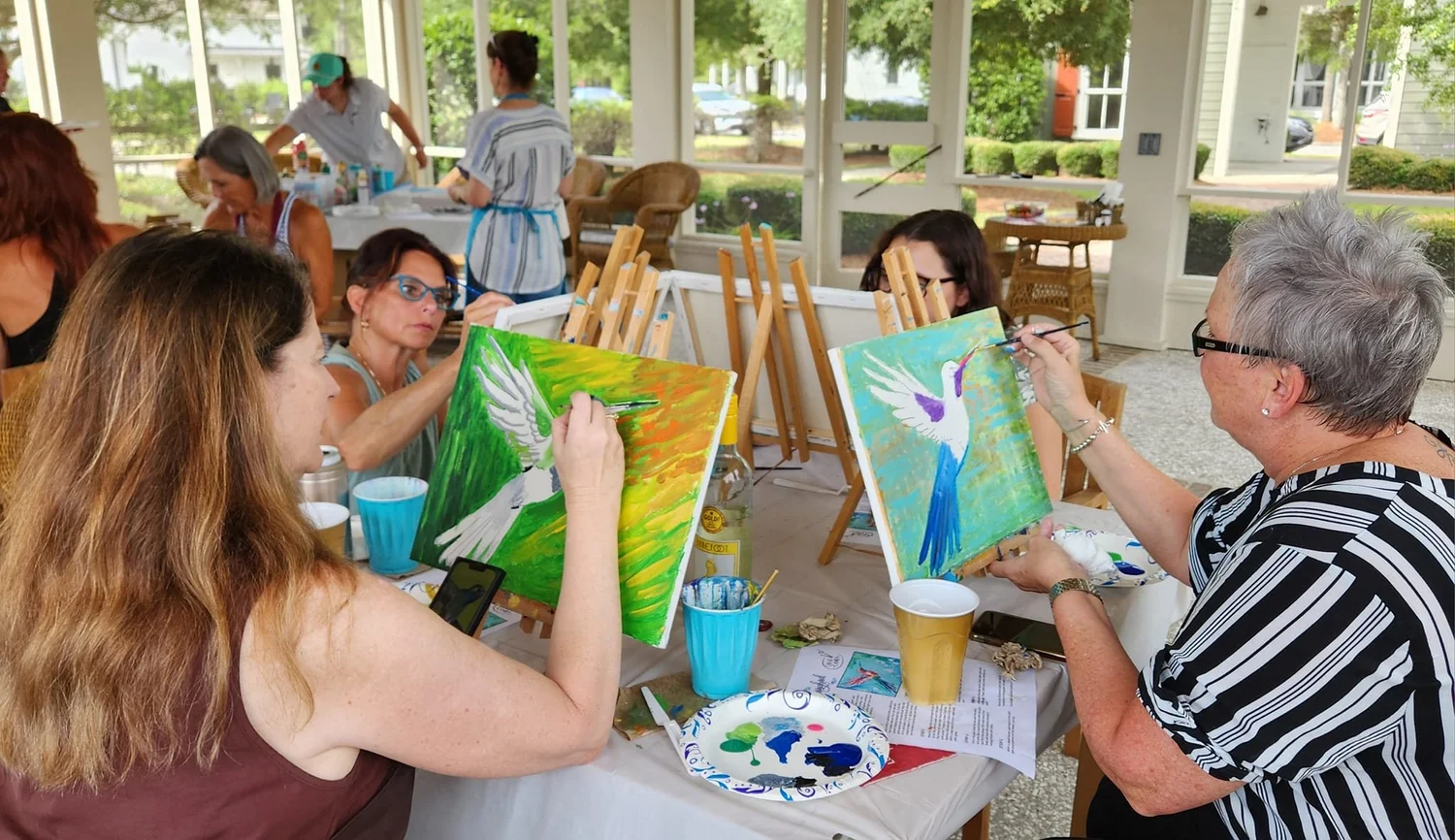 A group enjoying an in-person painting workshop