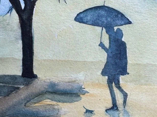 Silhouette of a figure with umbrella and reflection