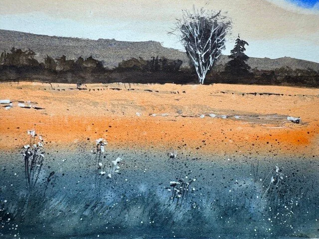 Speckled wild grasses and orange field details from the foreground