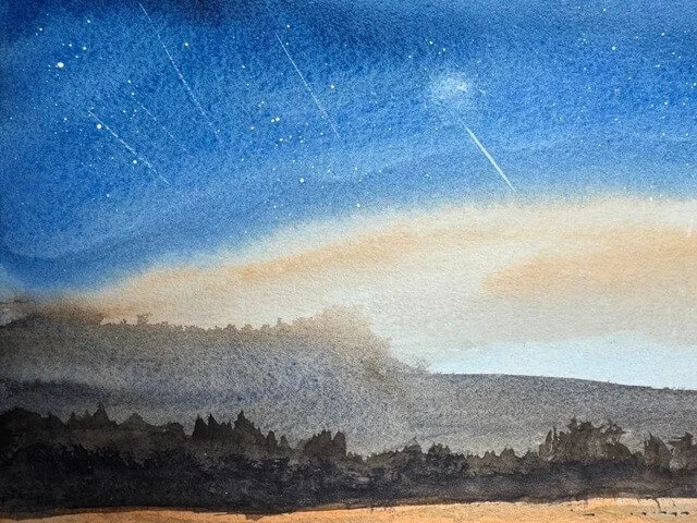Meteor streaks and stars in the deep indigo sky