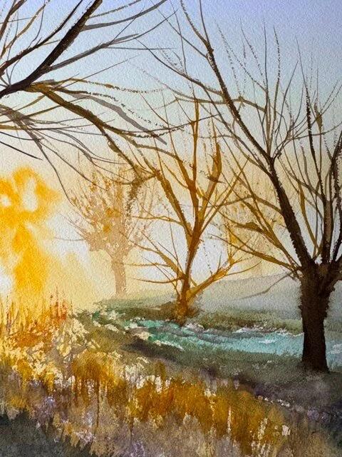 Bare winter trees fading into mist and sunlight in a peaceful watercolor scene