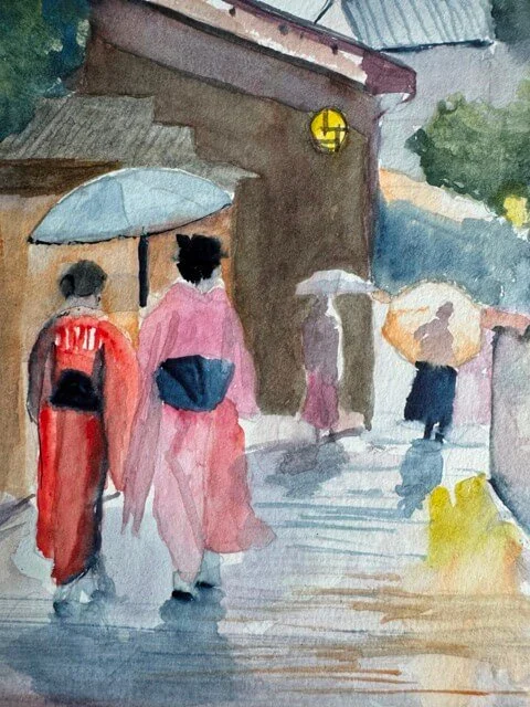Two people in pink and red kimonos walking with umbrellas on a stone path in Japan