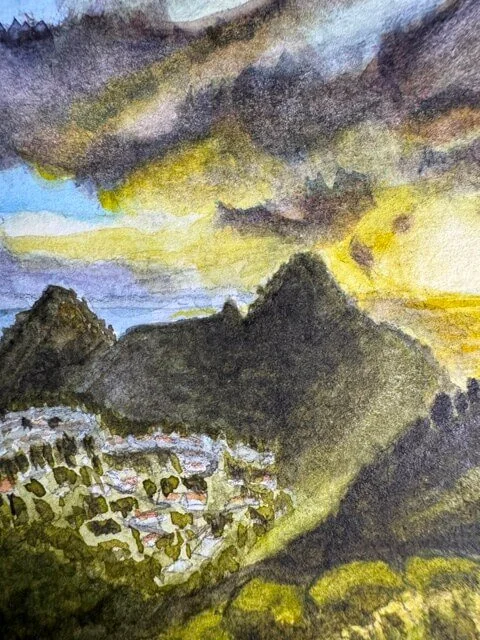 Highlight on golden sunset and mountain silhouettes under dramatic clouds