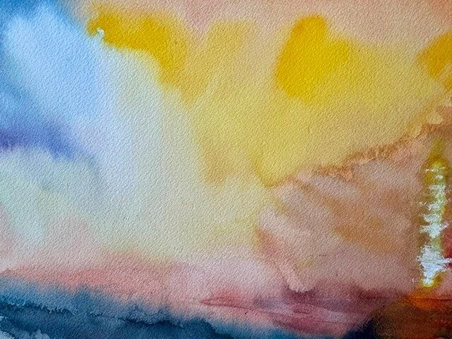 Abstract blending of pale yellow and soft blue watercolor clouds on textured paper.