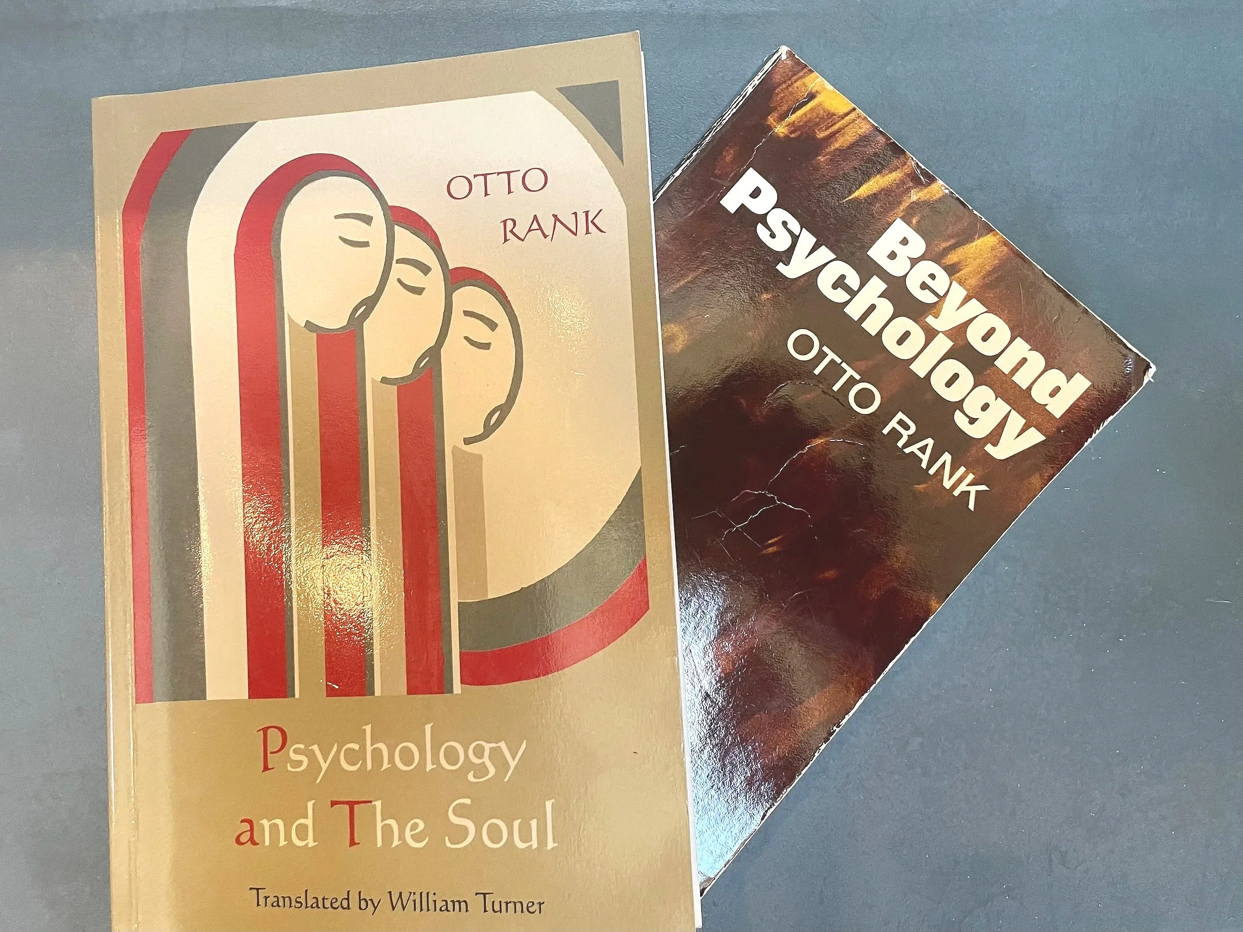 A book titled 'Psychology and The Soul' by Otto Rank, and another book titled 'Beyond Psychology' by the same author