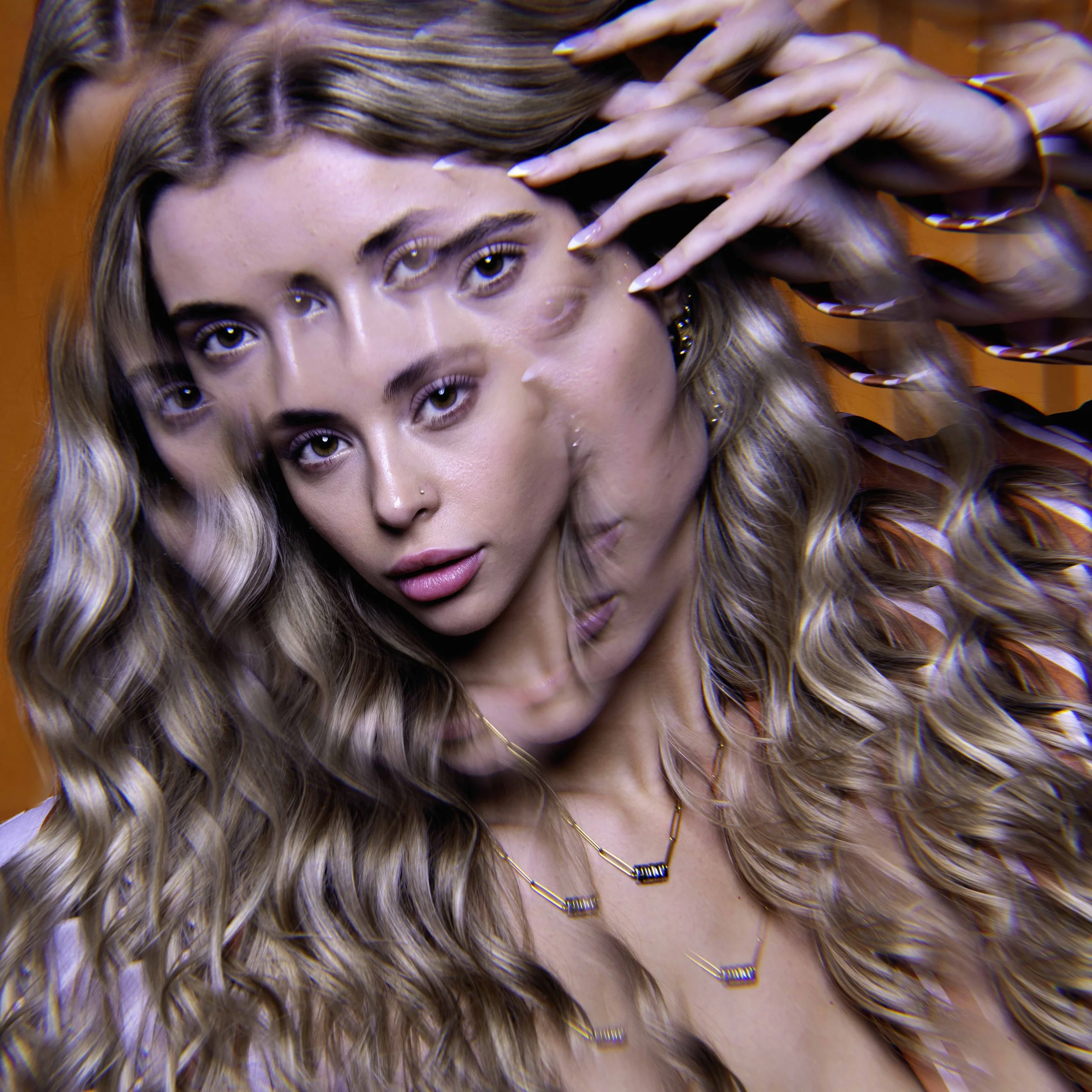 Creative beauty portrait of a woman framed by multiple hands with dramatic studio lighting