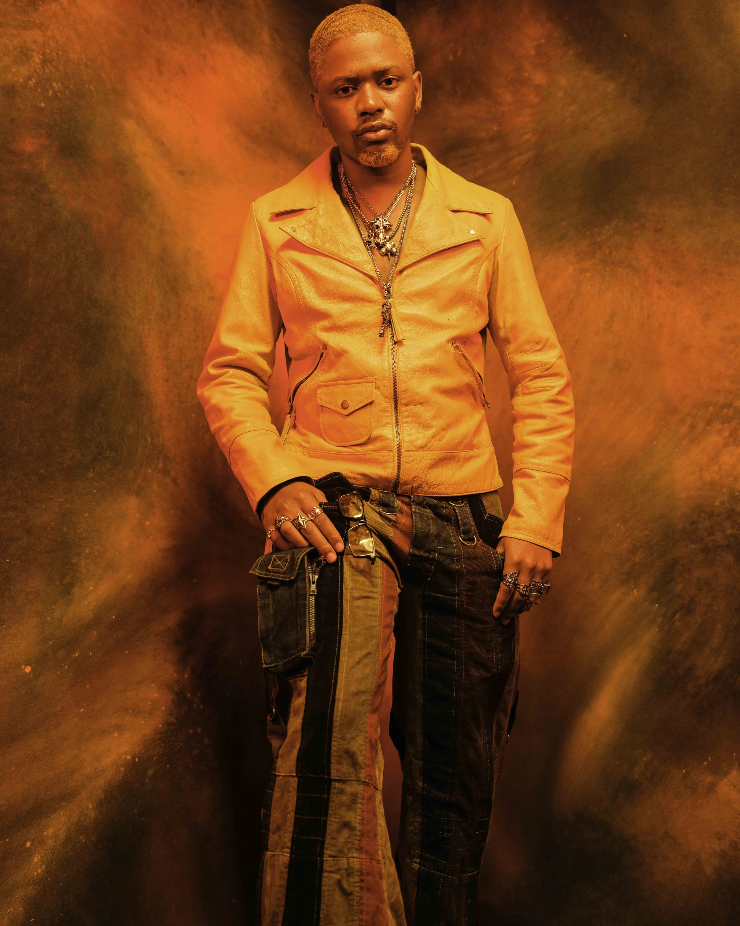 Creative portrait of a man in an orange suit against a dramatic textured orange background