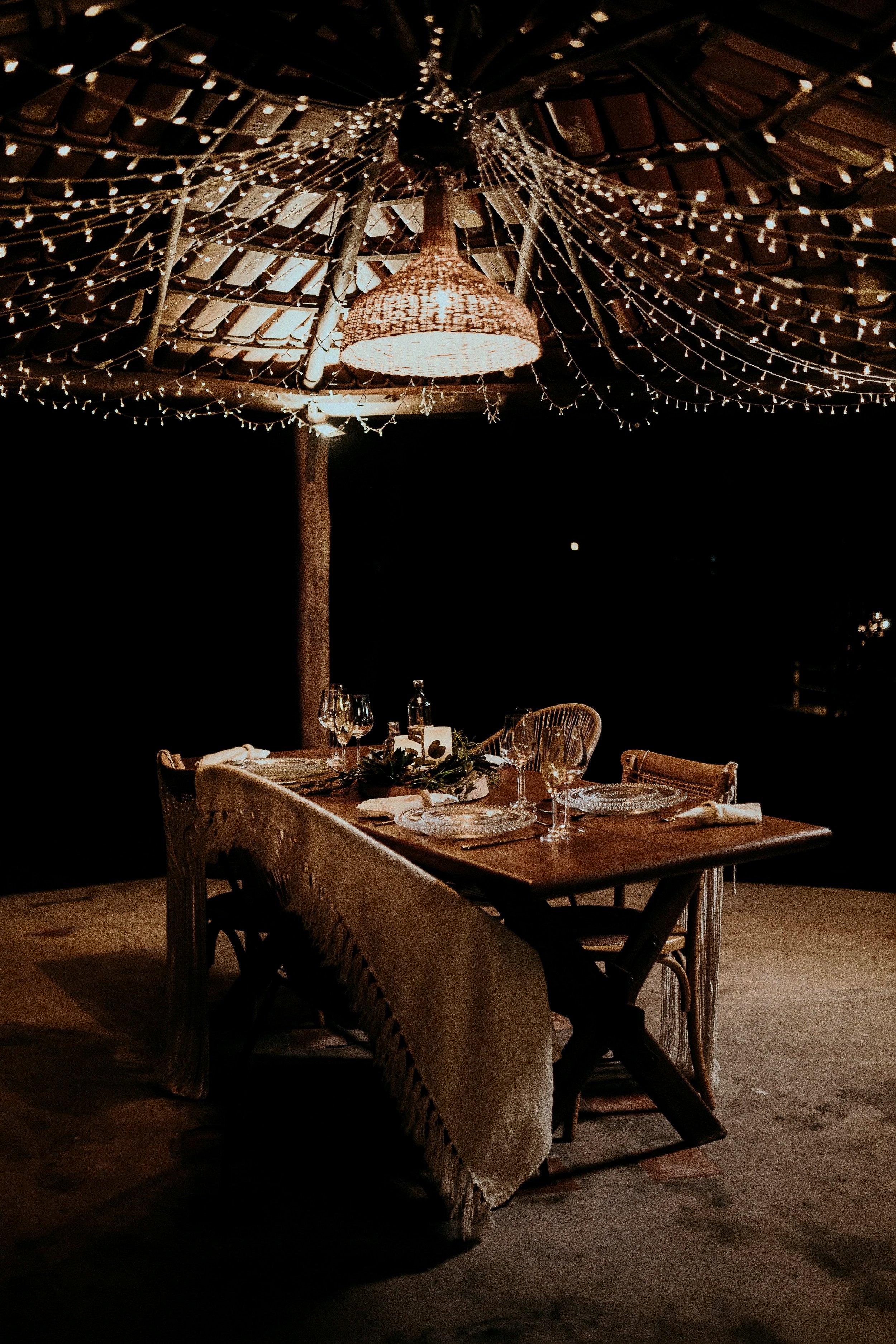 outdoor dining table set with plates and wine glasses