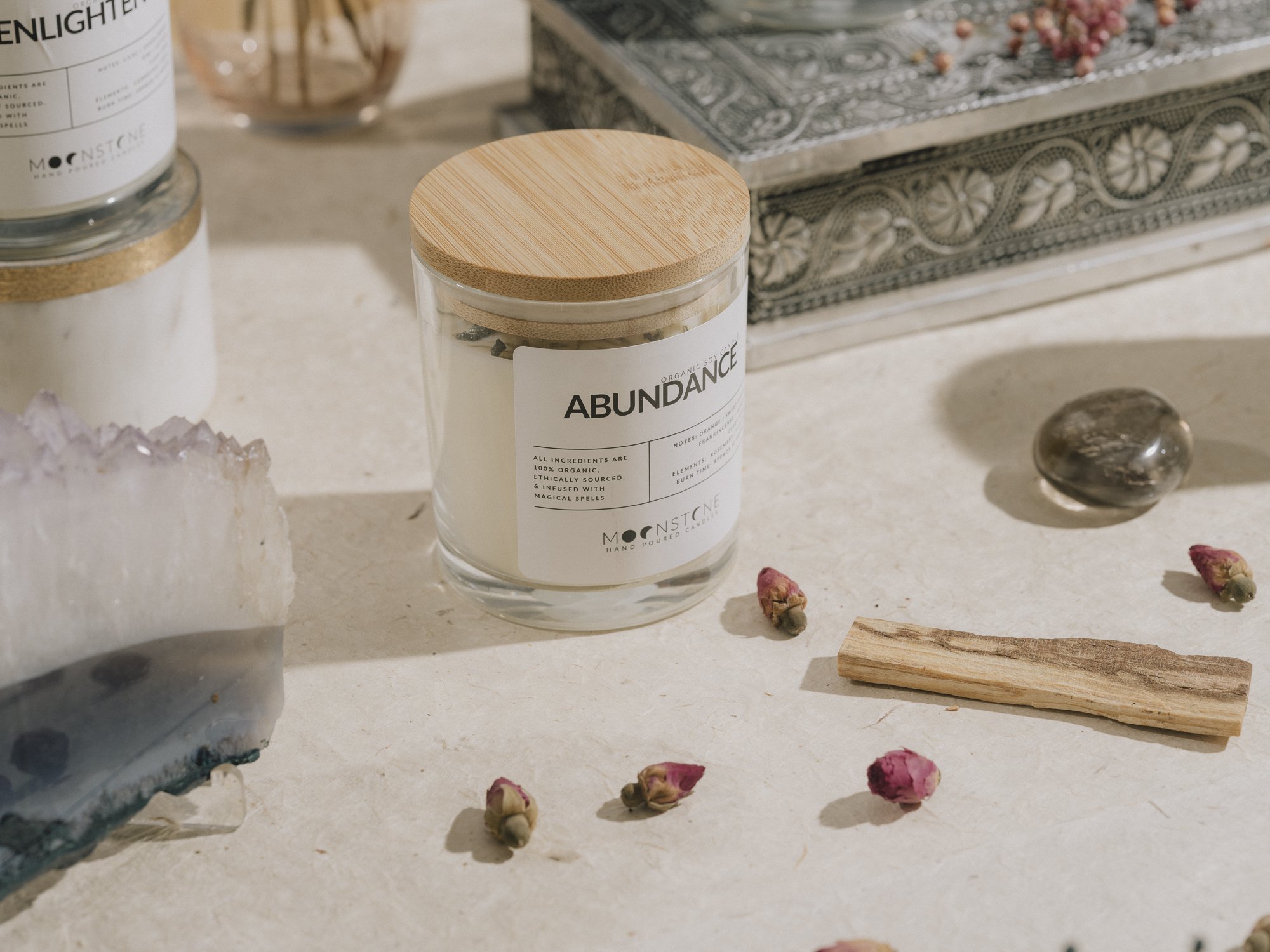 Artistic side angle shot of Moonstone Enchanted Ritual's Abundance Candle
