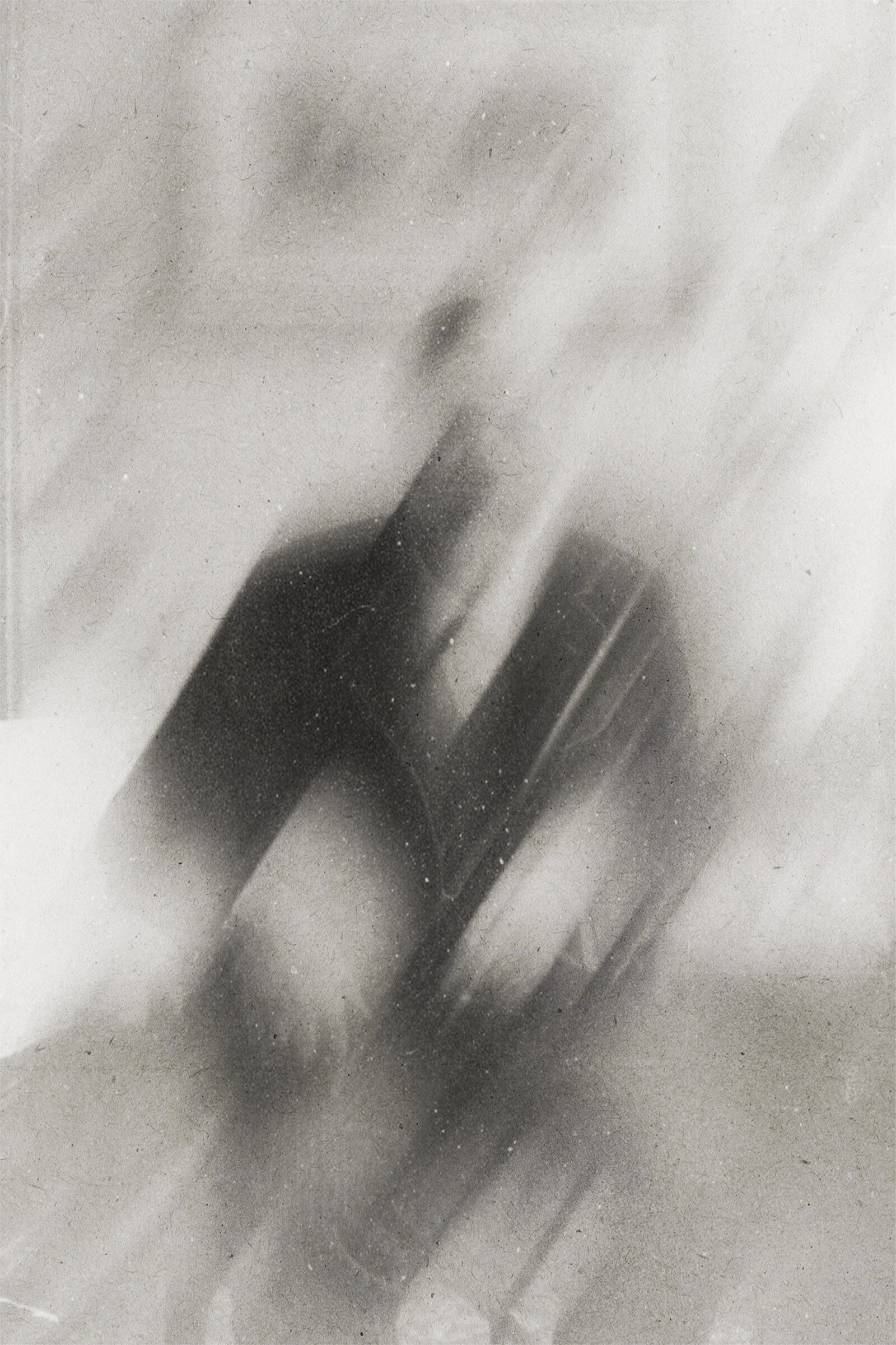 A person taking a mirror selfie with a smartphone, partially covered by mist or fog, in black and white.