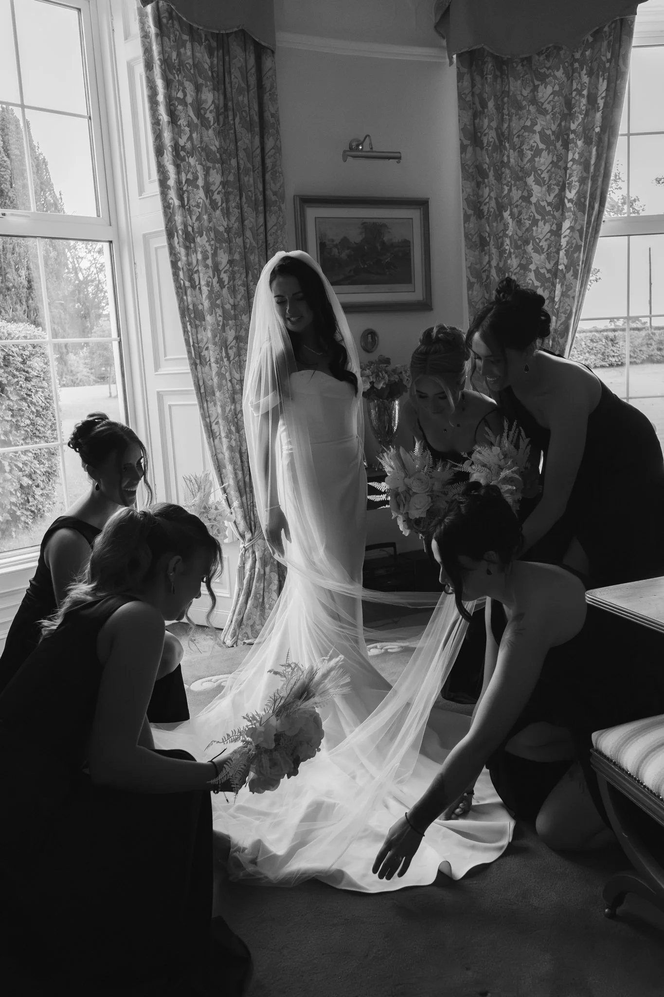 Candid photograph of Bride and her bridesmaids by GRAEI PORTRAIT wedding photography