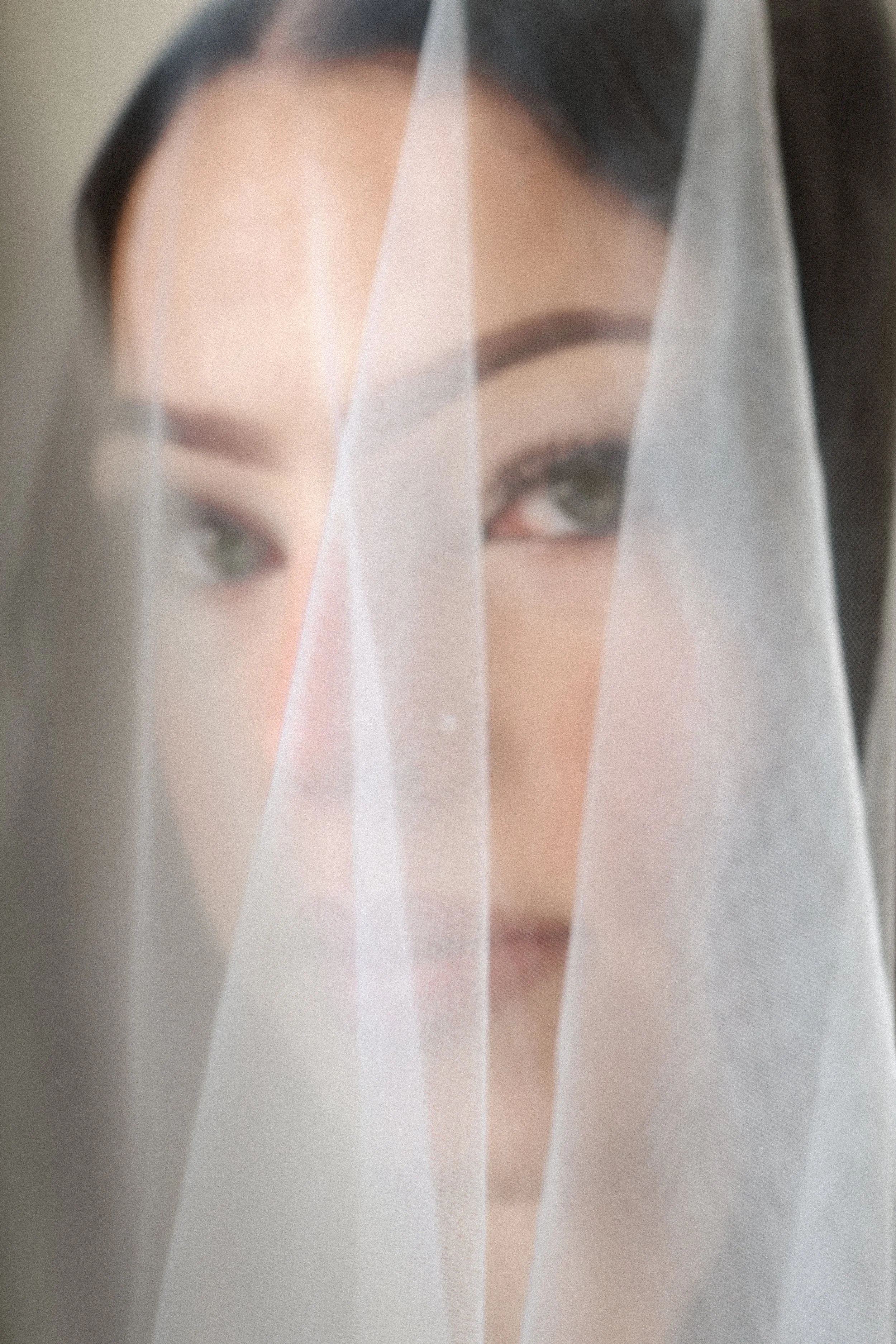 Fashion portrait of model through a veil photographed by Laura Graei Portrait fashion and lifestyle photography  Ireland