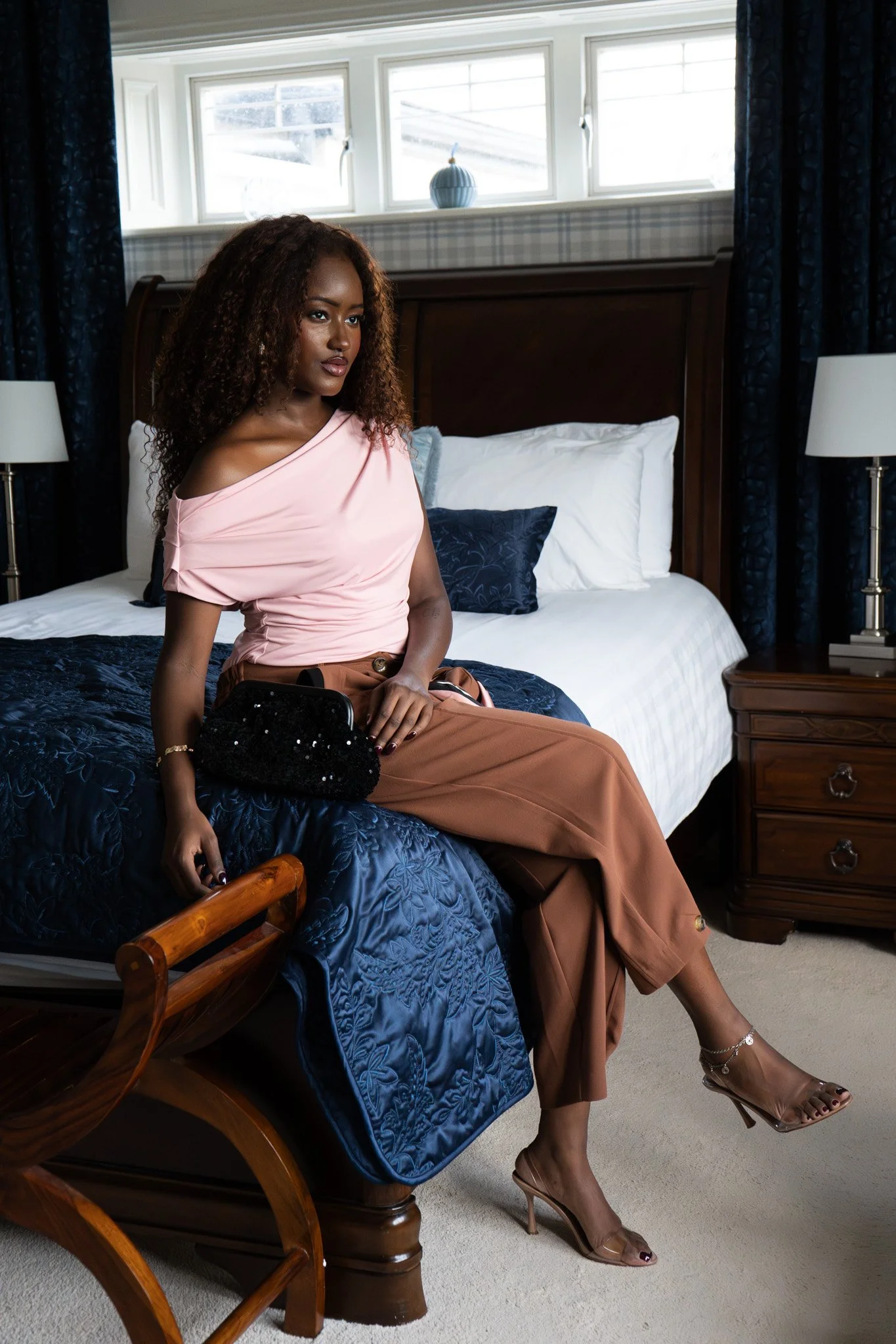 fashion photograph with model Candice from the pause agency wearing oh Molly pink top and brown trousers with a clutch bag by reign photographed by graei portrait in Limerick Ireland 