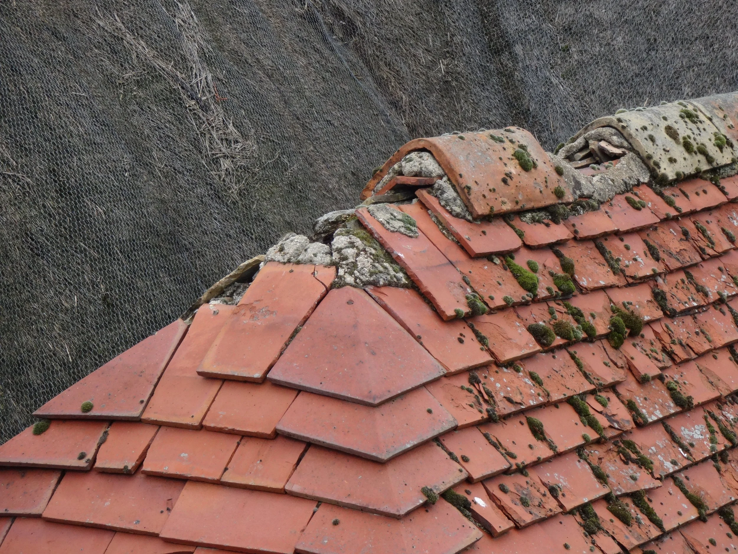 The old mortar has failed causing the roof covering to fall away.