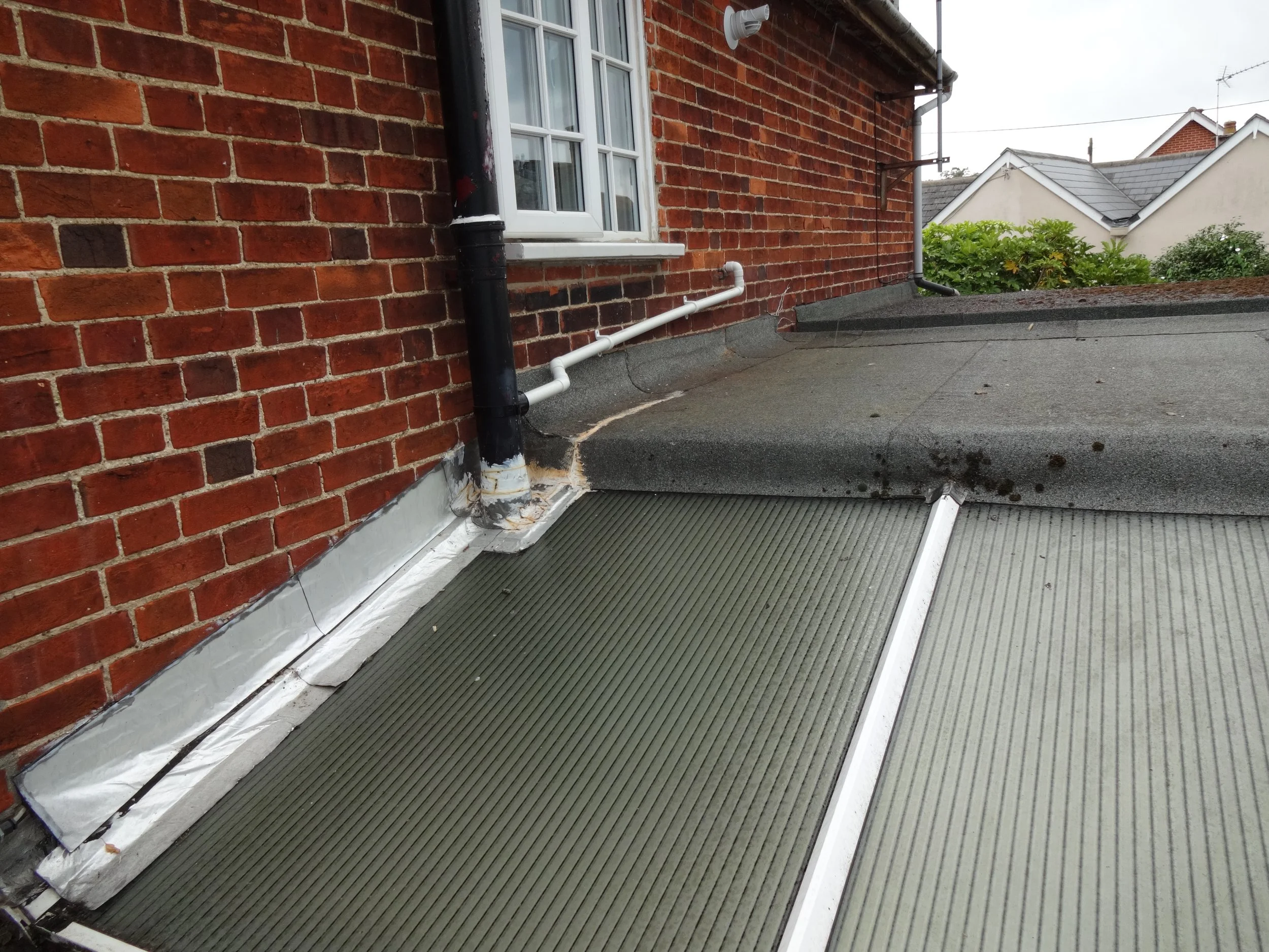 From above, the flat roof coverings are visible for inspection