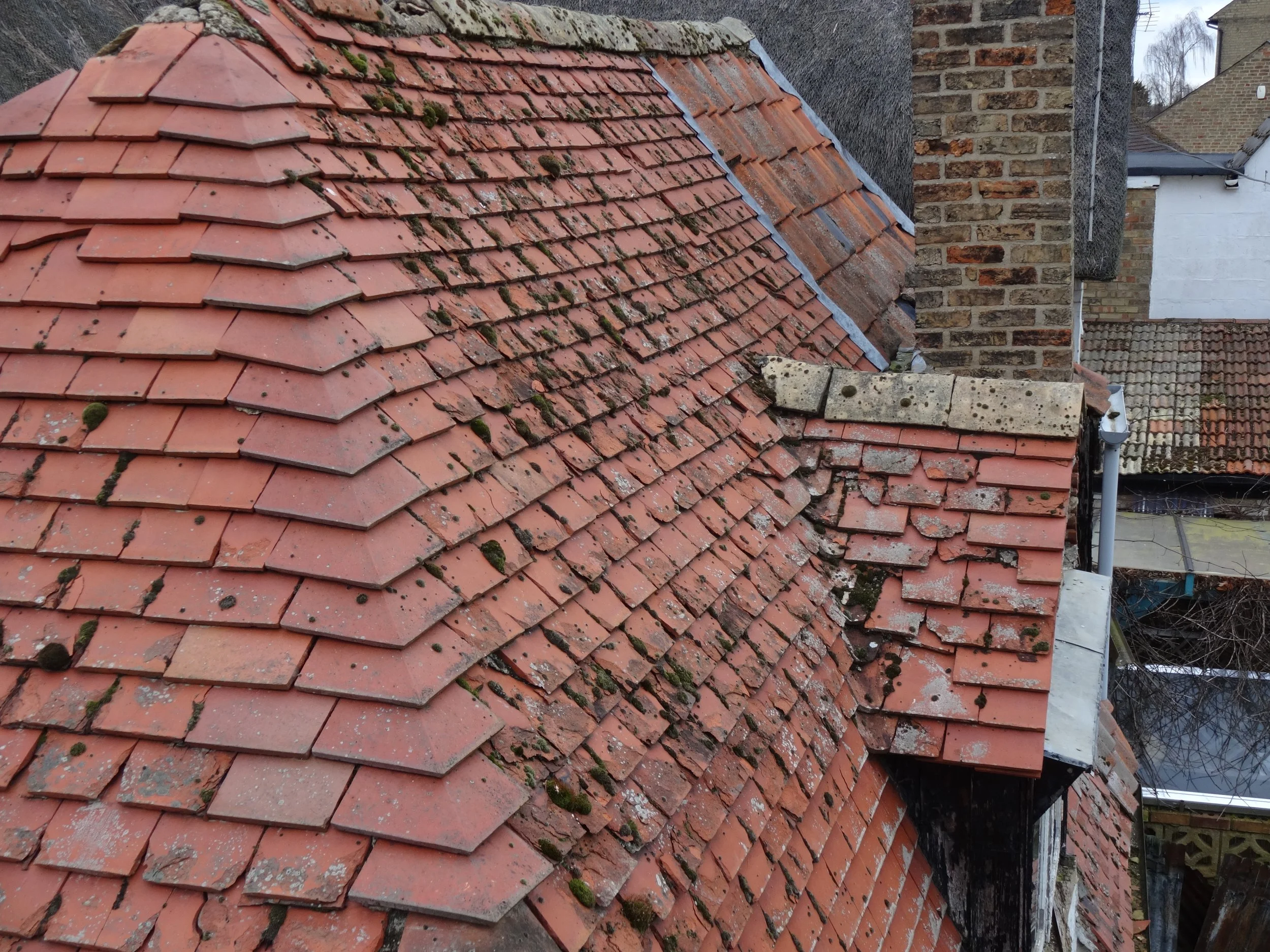 This roof covering has been patched but further repairs are needed now