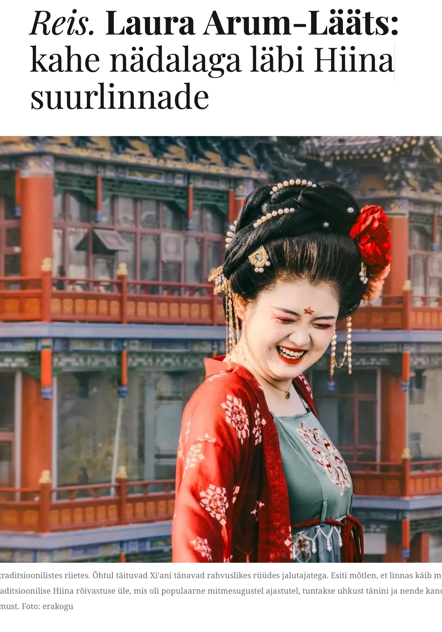 A woman dressed in traditional Chinese attire smiling with her eyes closed, in front of a traditional Chinese building with intricate architectural details.