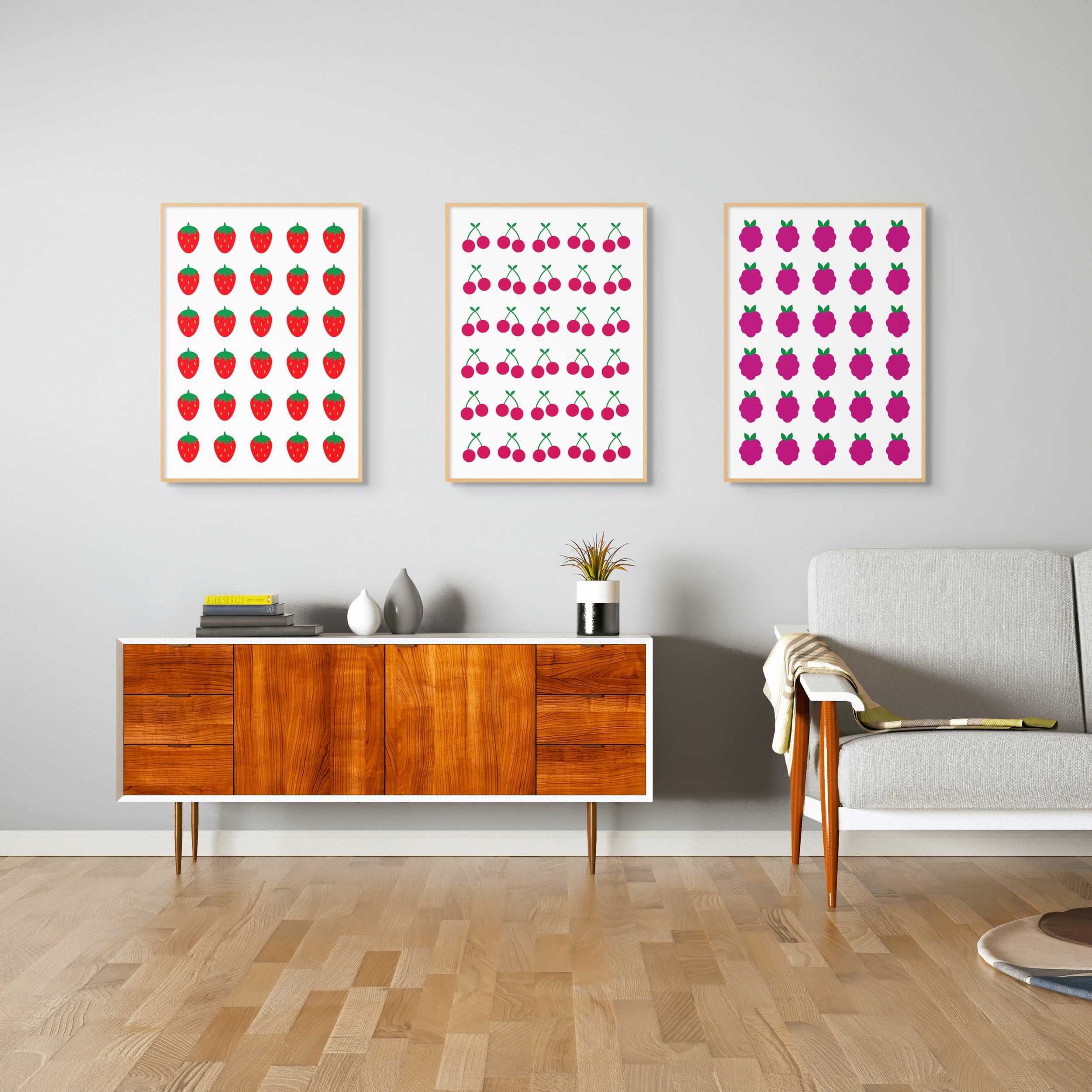 set of abstract prints for the home. strawberry print, raspberry print and cherry print on wall of living room