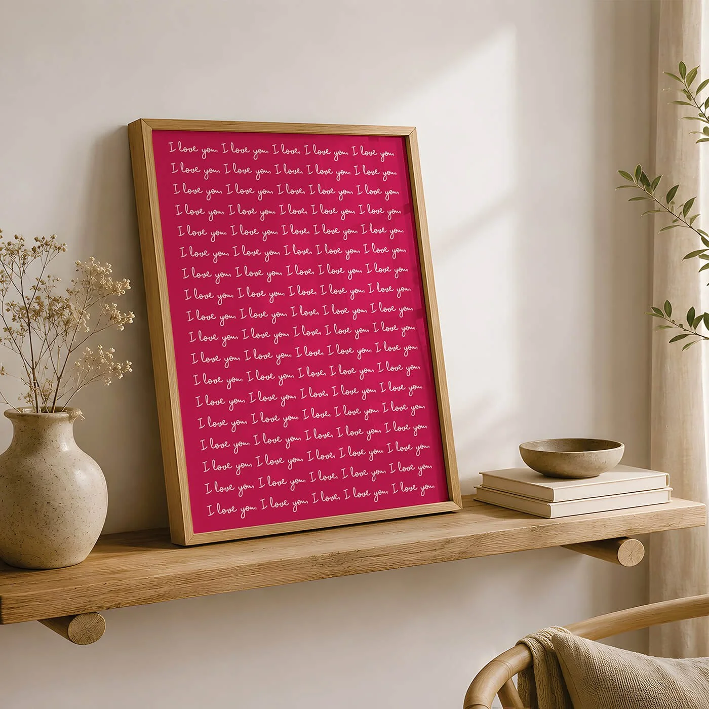 Red and White I Love You Print displayed in a wooden frame on a modern sideboard alongside a contemporary lamp and green plant