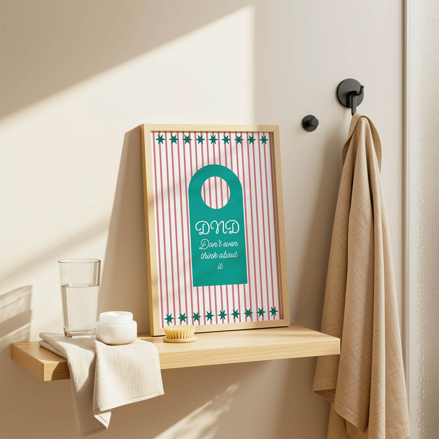 Green Do Not Disturb Print styled in a wooden frame on a modern bathroom shelf in a contemporary bathroom