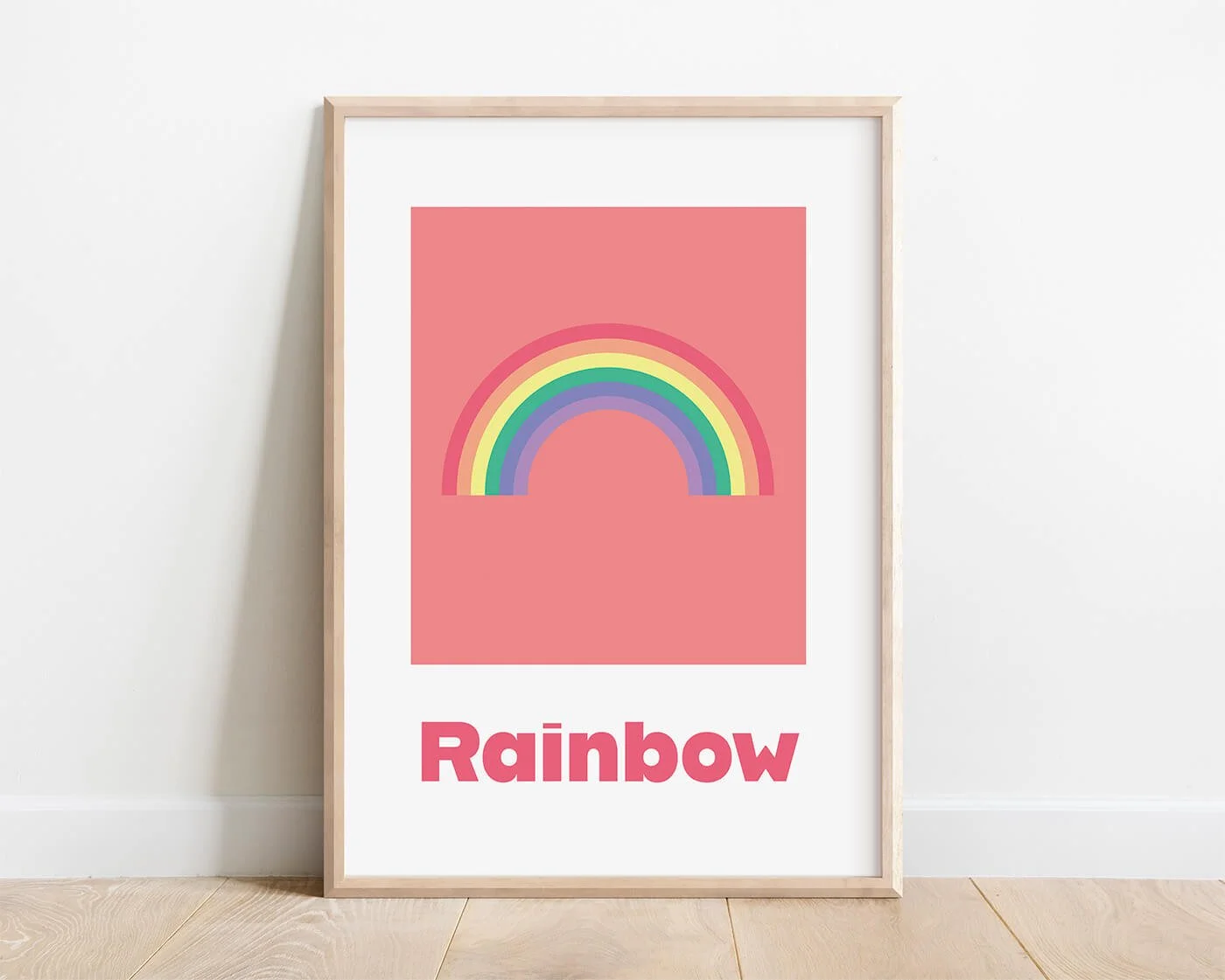 Retro rainbow learning print and kids word recognition art, displayed in a light wood frame against a white interior wall.