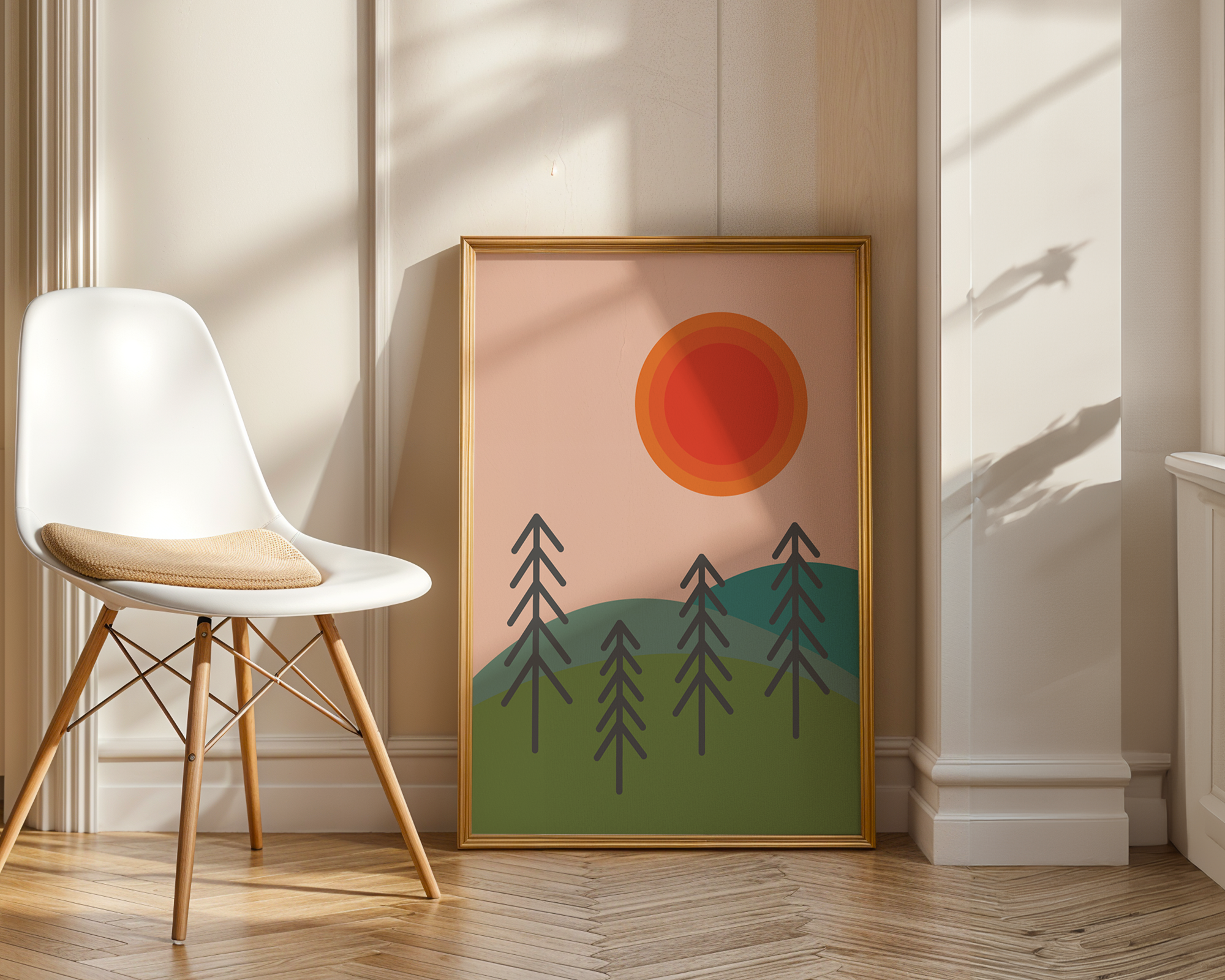 sun and tree print in wooden frame leaning against wall