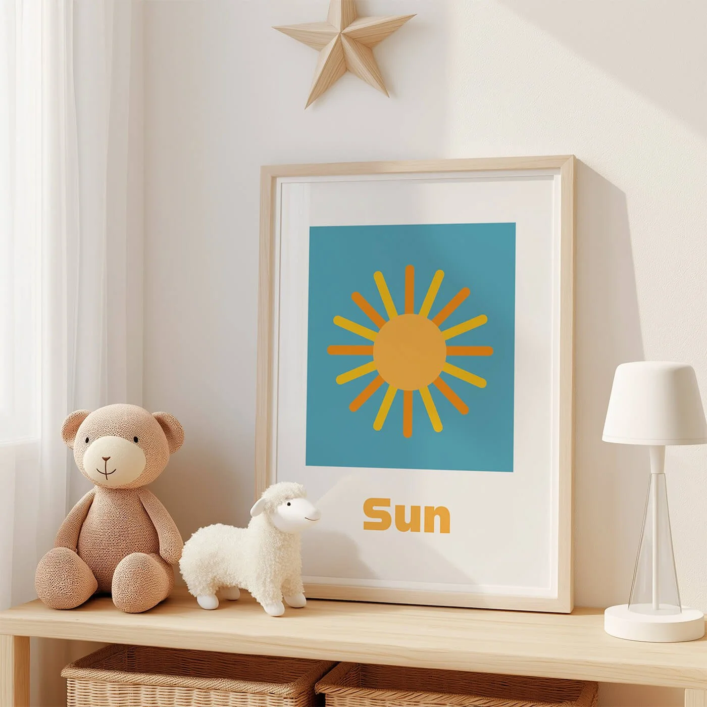 Sun word recognition children's educational print framed on a neutral nursery shelf next to two soft plush toys