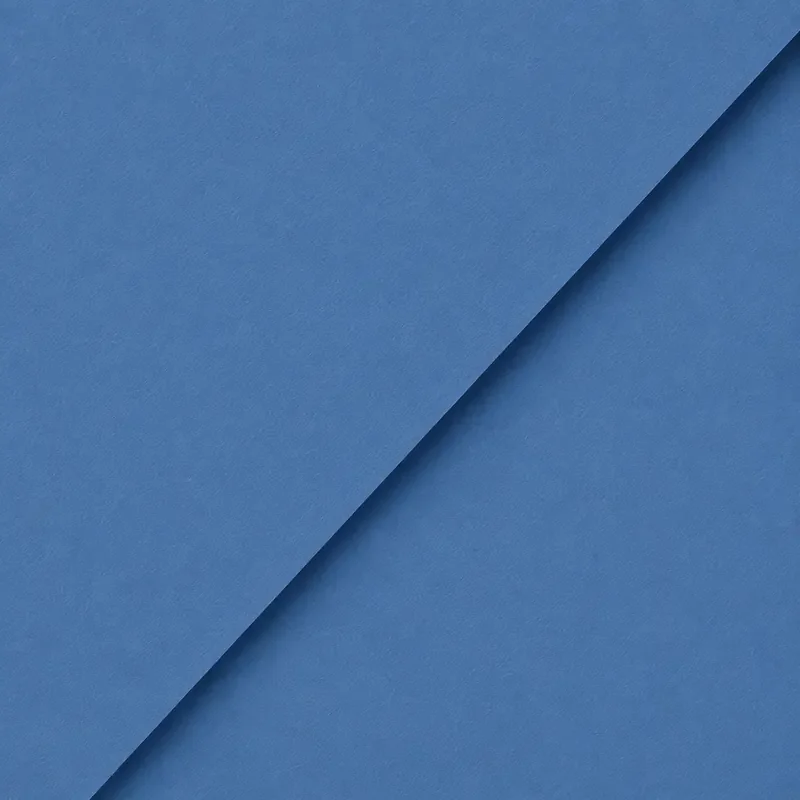 Close-up of layered blue paper with a diagonal fold.