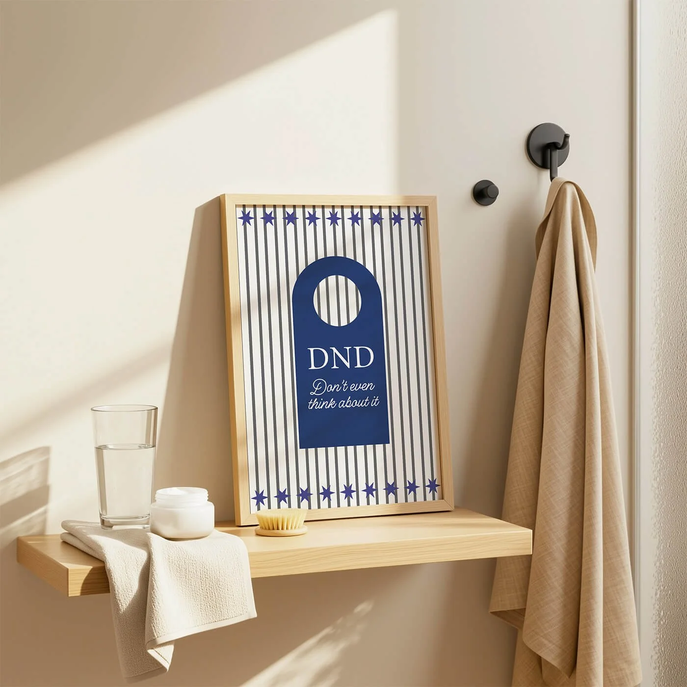 Blue Do Not Disturb Print displayed in a wooden frame on a contemporary bathroom shelf with modern décor