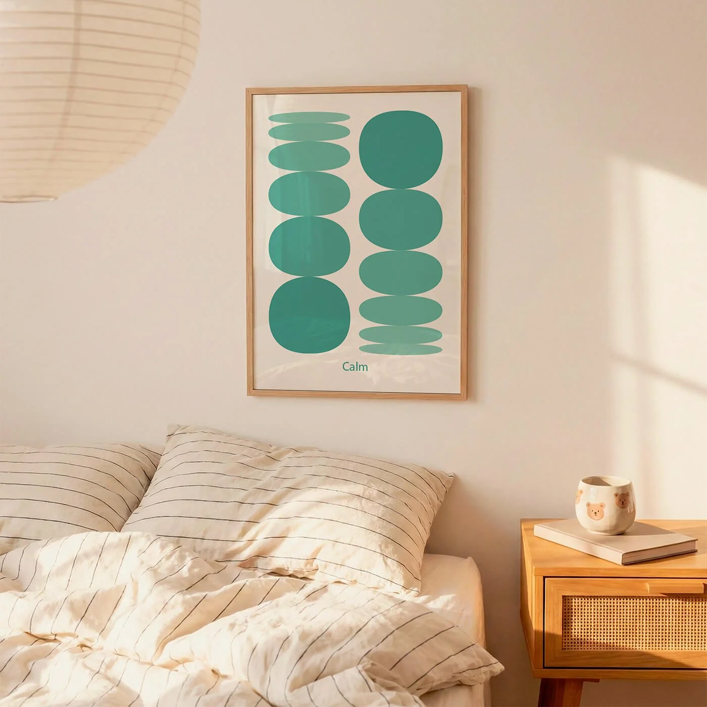 Framed green modern spherical art print hanging above a bed in a neutral bedroom