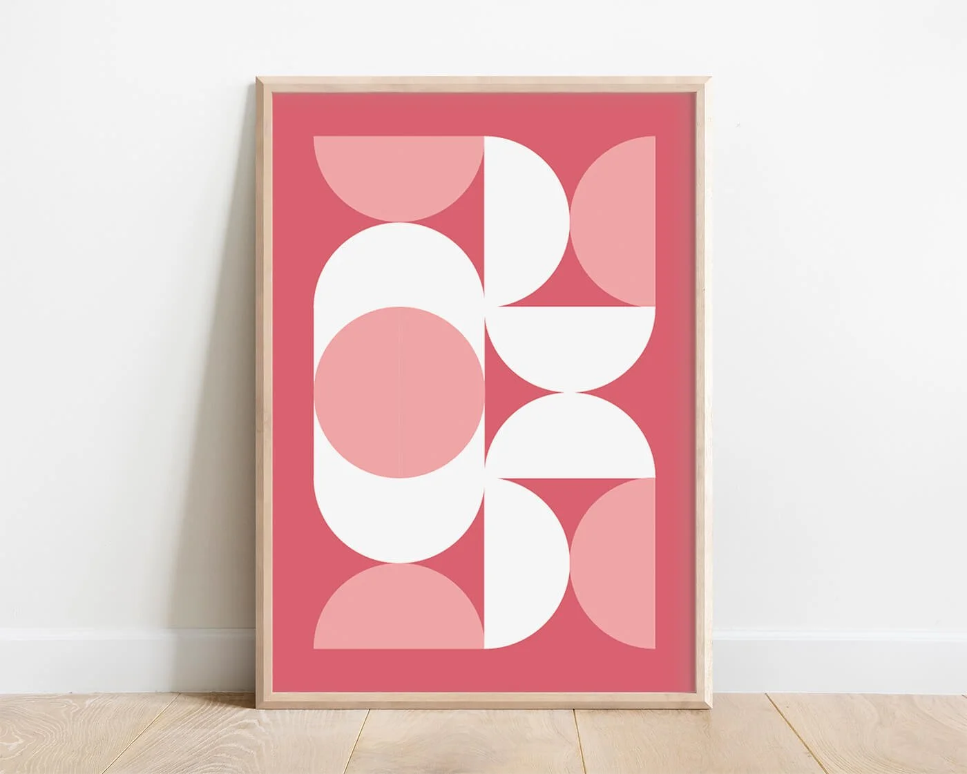 geometric wall art print in oak frame against white interior wall