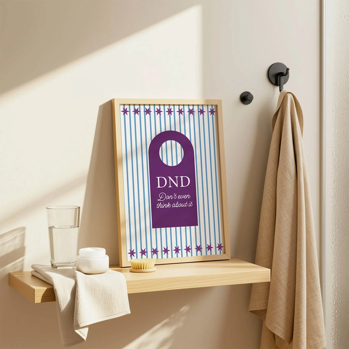Burgundy Do Not Disturb Print in a wooden frame displayed on a contemporary bathroom shelf within a modern interior
