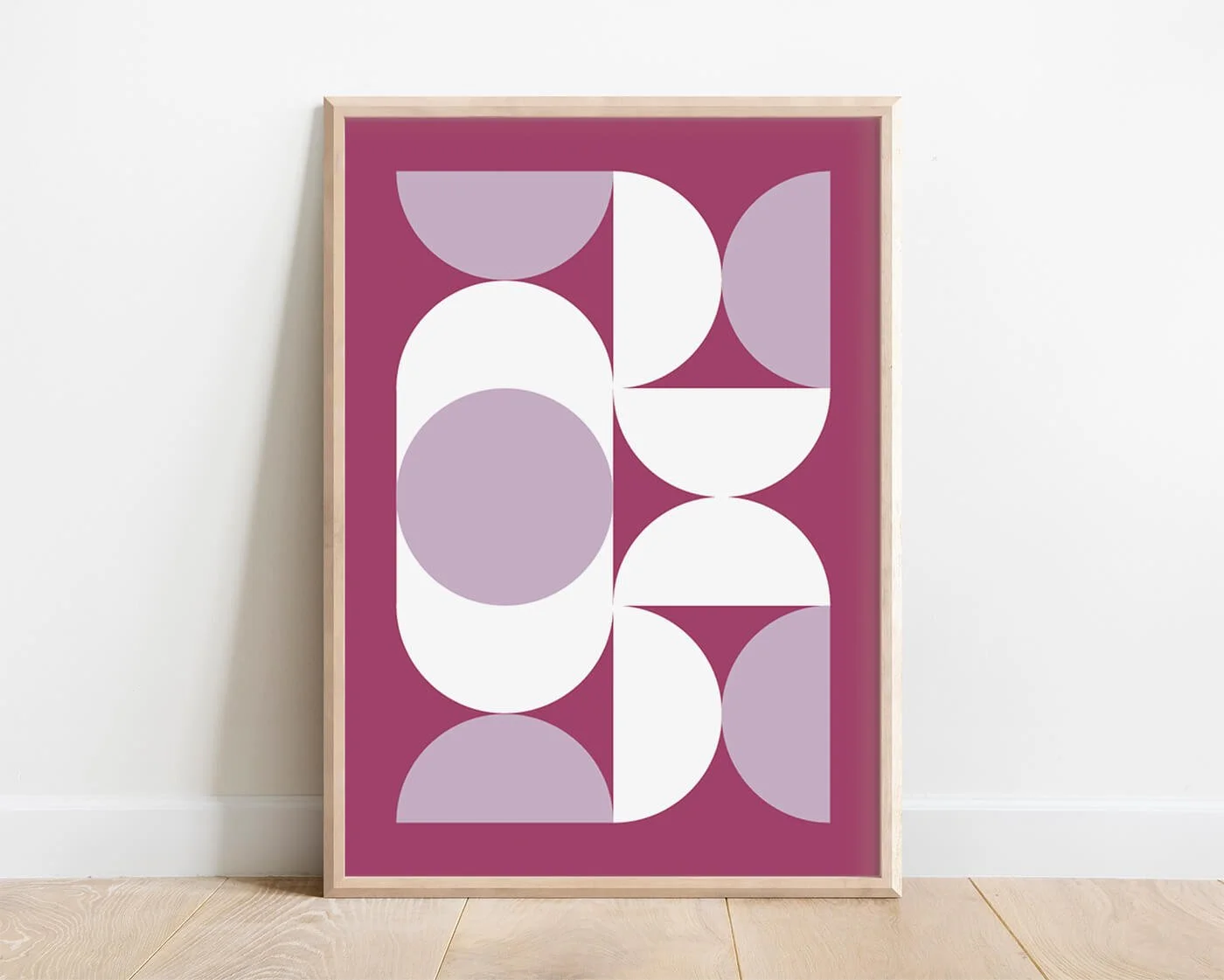 Purple Bauhaus geometric wall art print in oak frame against white interior wall