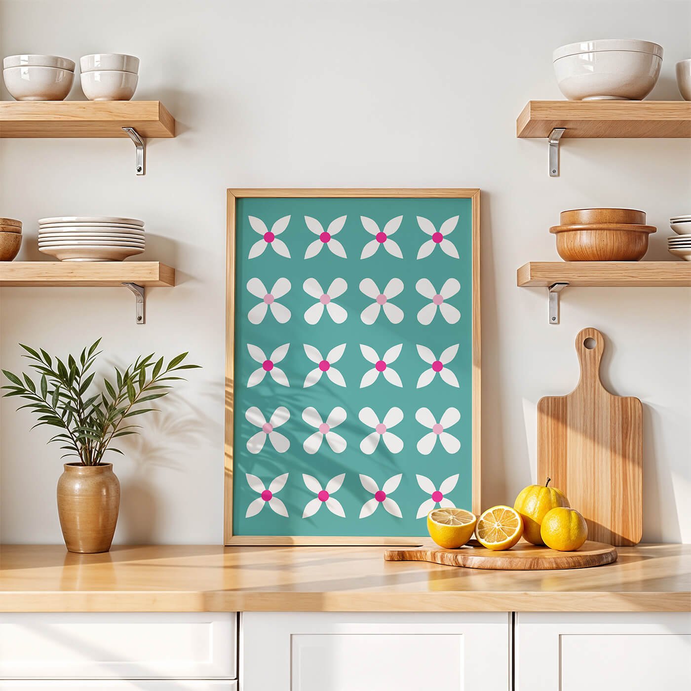 Green Abstract Flowers Print in a natural wooden frame displayed in a bright Scandinavian-style white kitchen