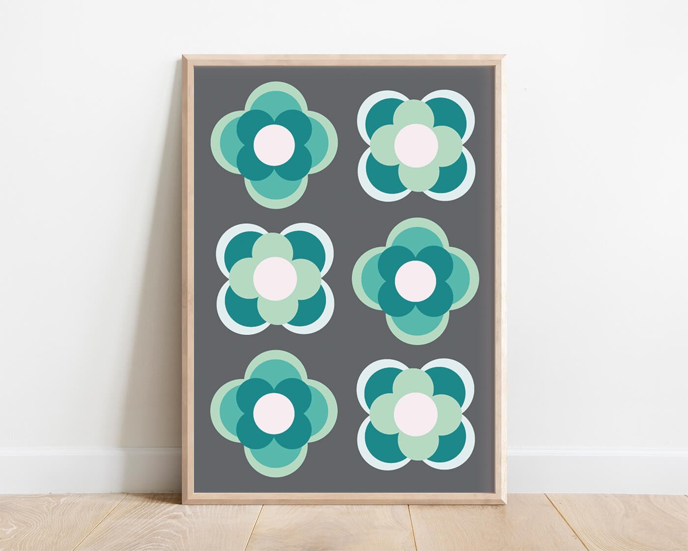 Green contemporary flower print in a light wooden frame against a white background
