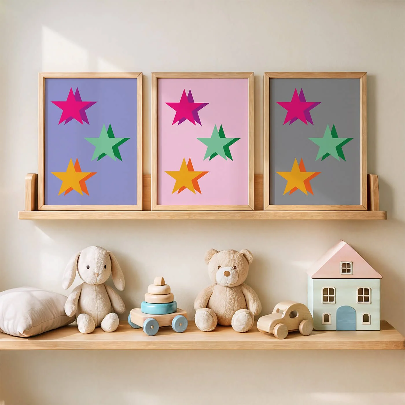 framed set of colourful abstract star prints on wooden shelf with shelf of kids stuffed toys beneath