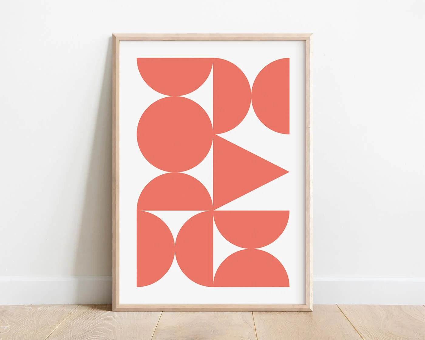 Coral Abstract Forms Print presented in a contemporary wooden frame on a white background.