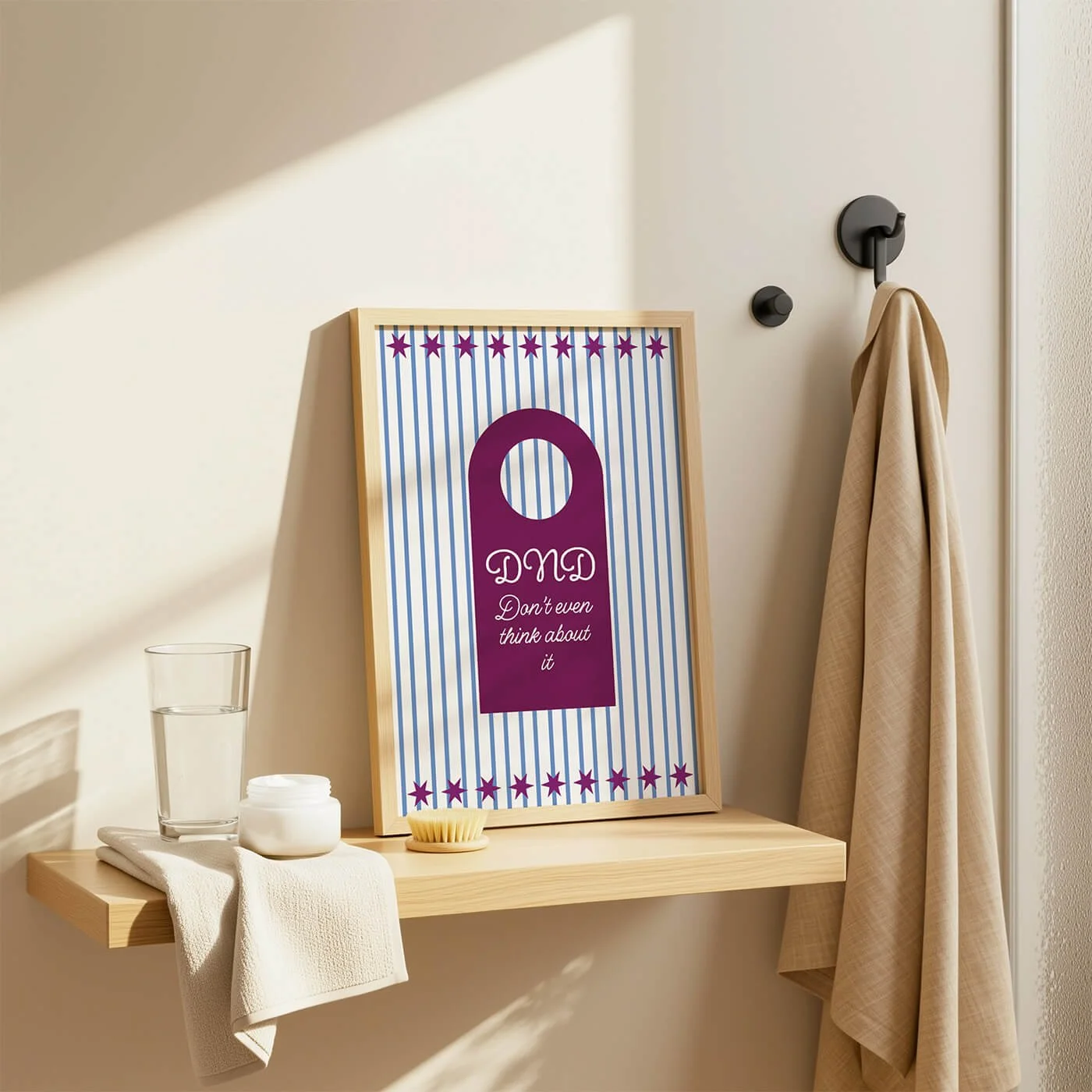 Burgundy Do Not Disturb Print in a wooden frame displayed on a contemporary bathroom shelf within a modern interior