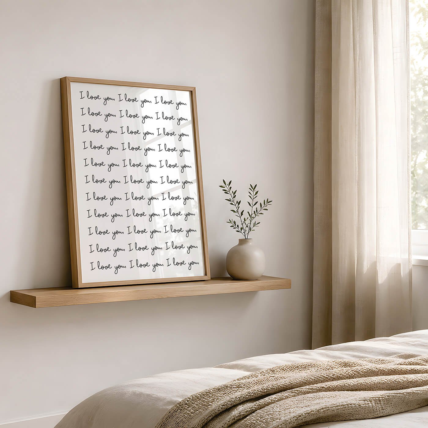 Black and White I Love You Print in a modern wooden frame displayed on a wooden sideboard beside a contemporary lamp and leafy plant.