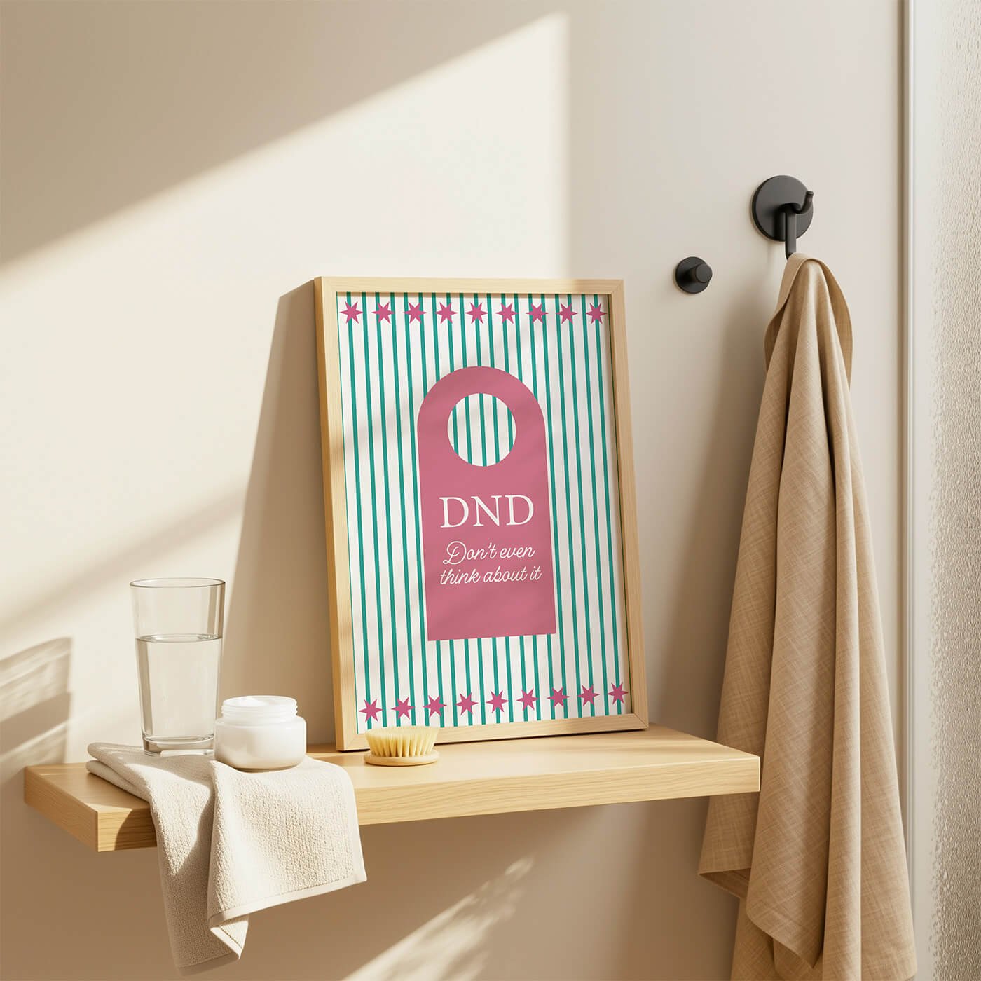 Pink Do Not Disturb Print presented in a wooden frame on a stylish bathroom shelf in a modern bathroom