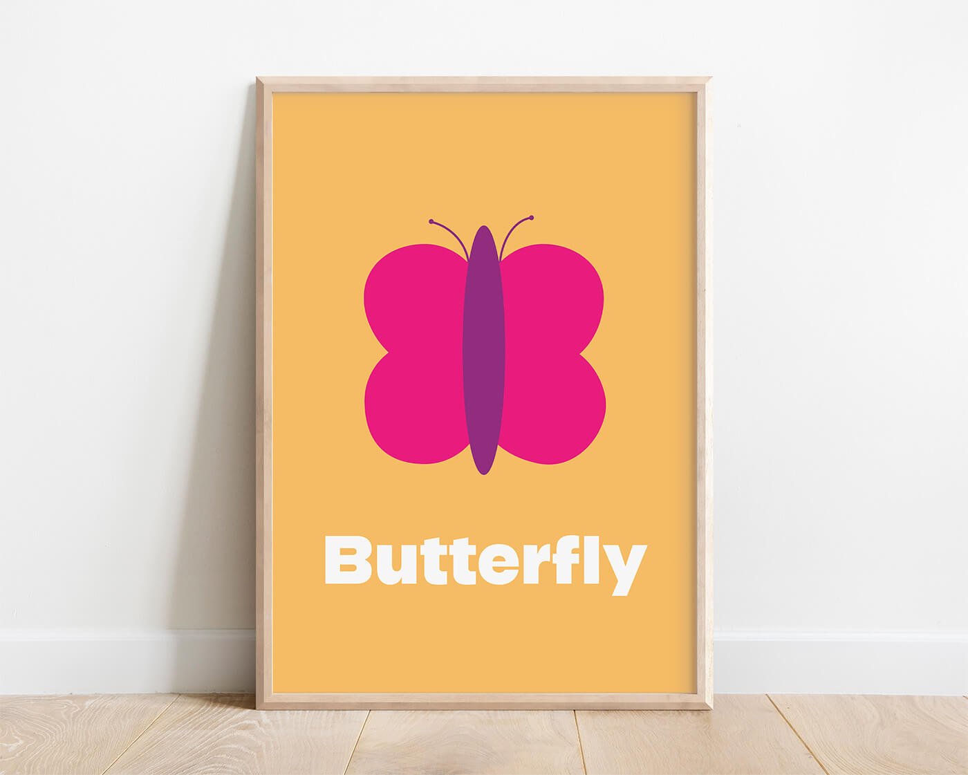 Butterfly Learning Print in a modern oak frame displayed on a white interior wall. Contemporary butterfly wall art with a colourful background and the word "Butterfly" beneath the illustration.