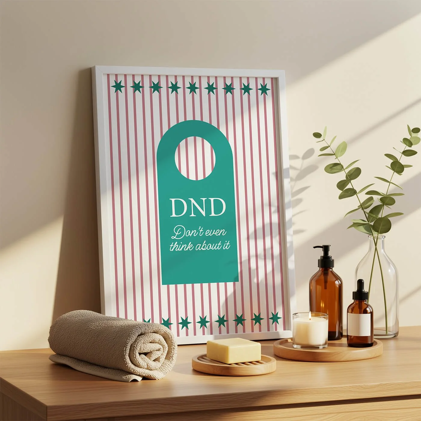 Framed typography print featuring pink vertical stripes and a teal door hanger graphic reading DND Don't even think about it