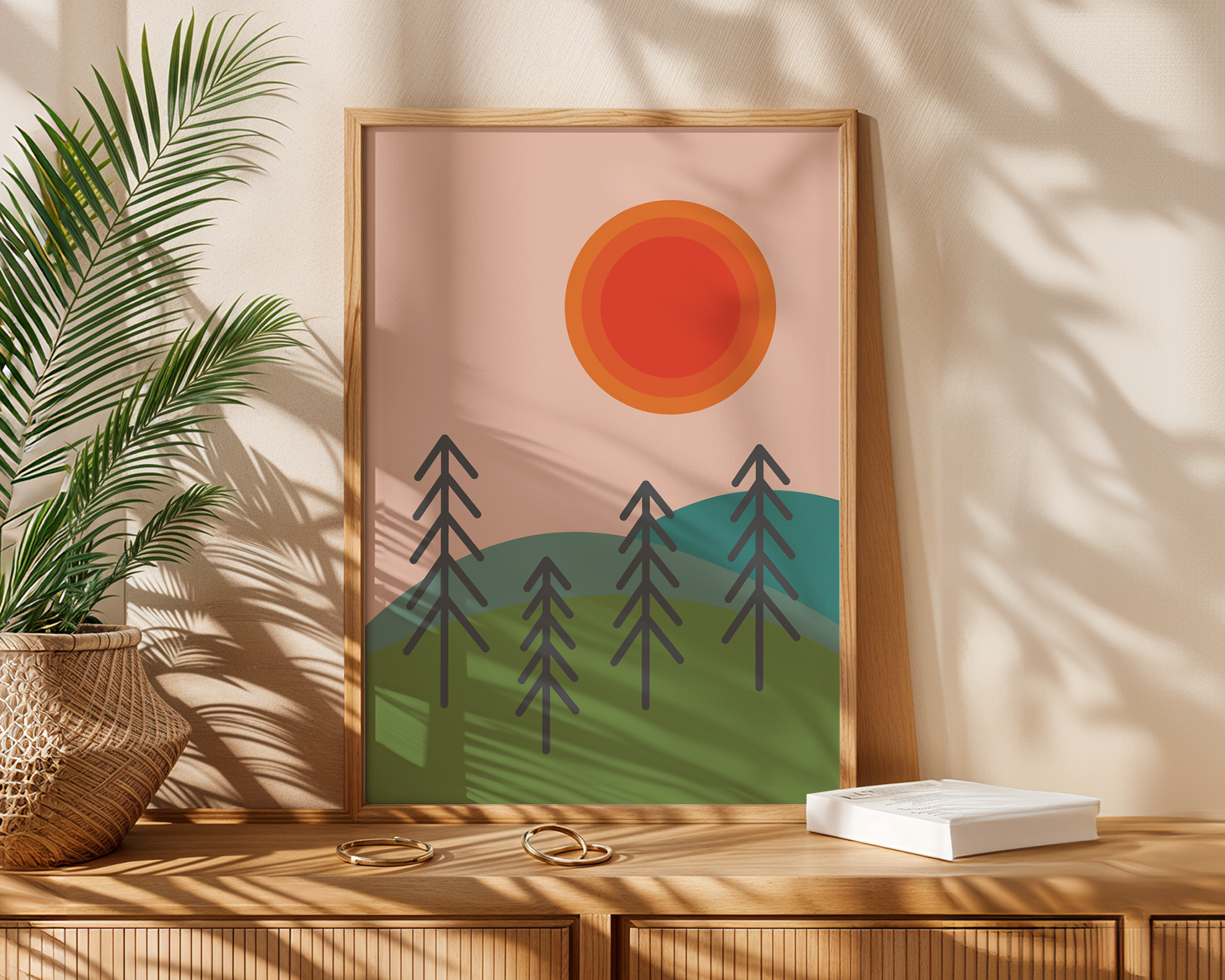 sun and tree print in frame next to palm plant