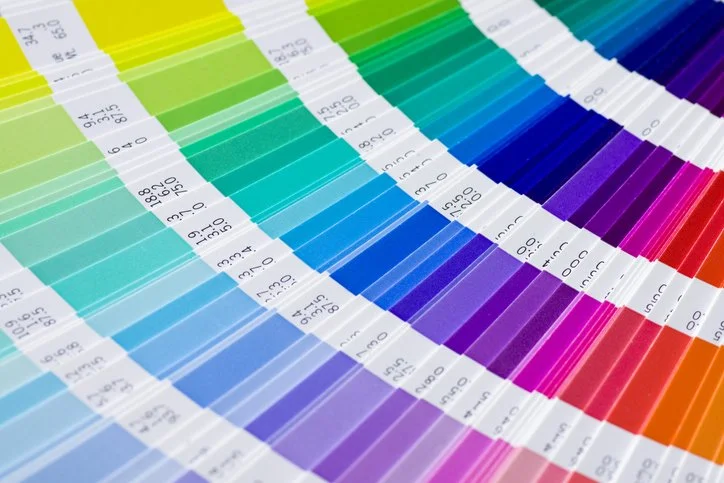 Color swatch fan deck displaying various shades in a rainbow pattern.