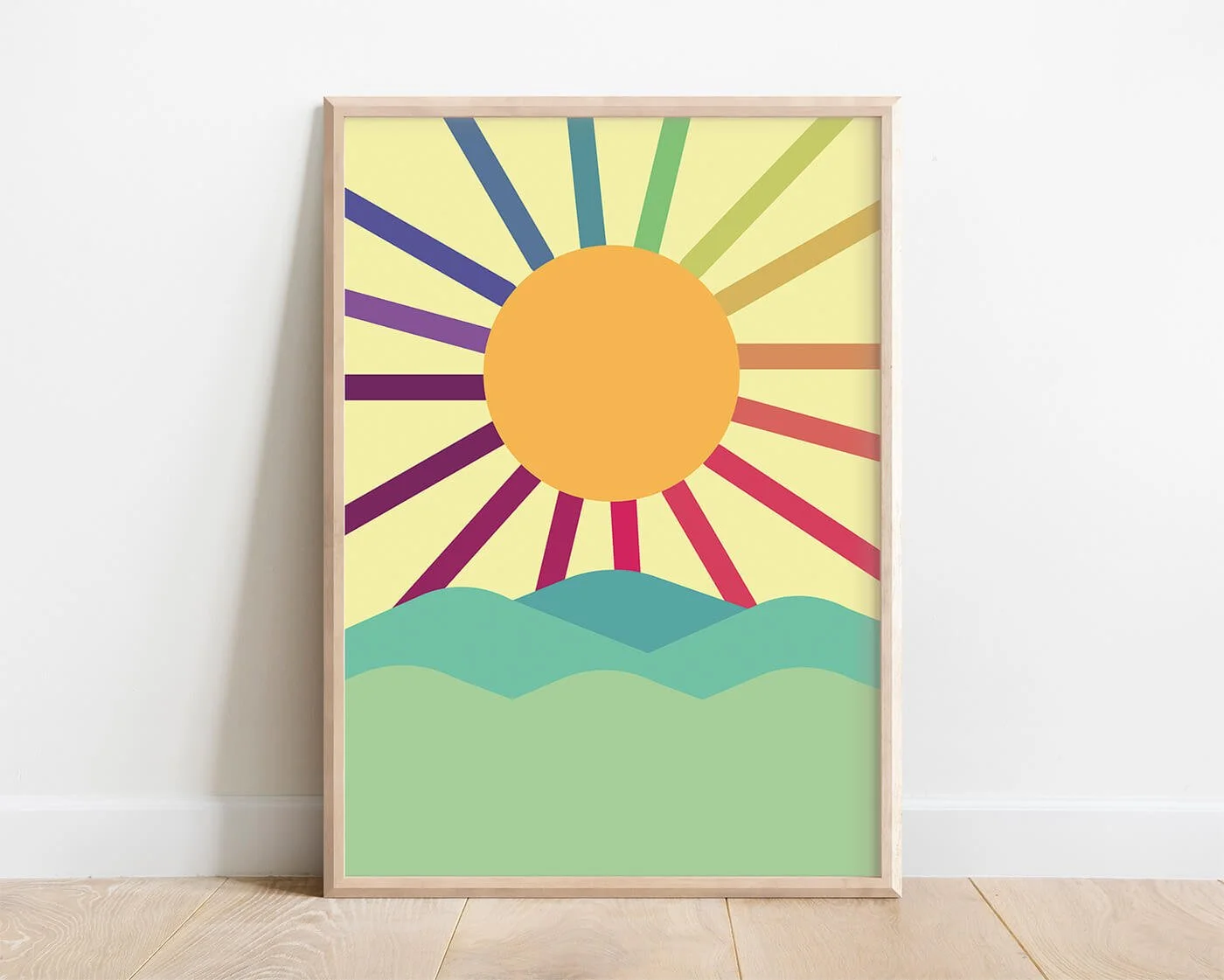 Framed rainbow wall art print featuring sun with rainbow strands and green hills under a soft sky