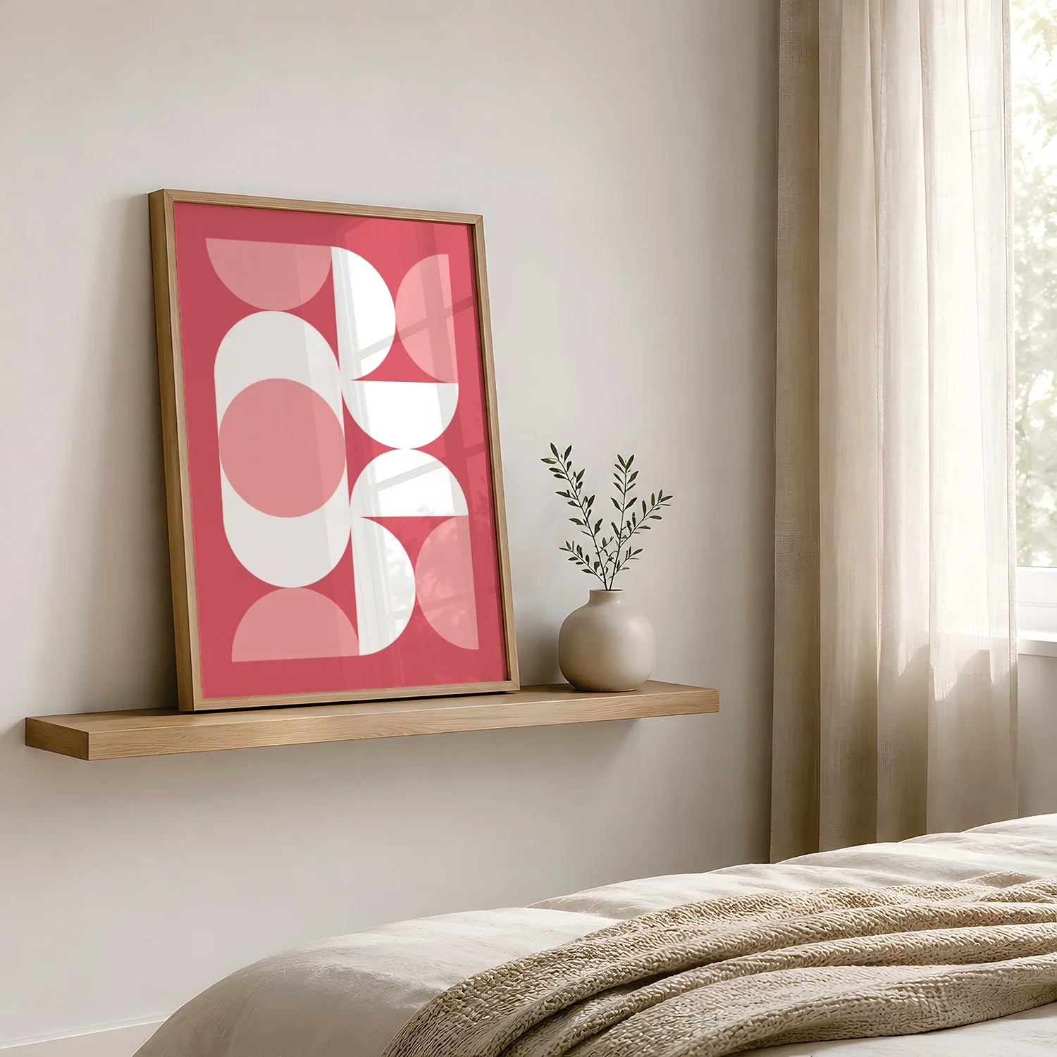 A bedroom with a bed that has striped bed linens, a wooden nightstand with a bear-themed mug, and a framed poster with orange circles and the word "Glow" on a white wall.