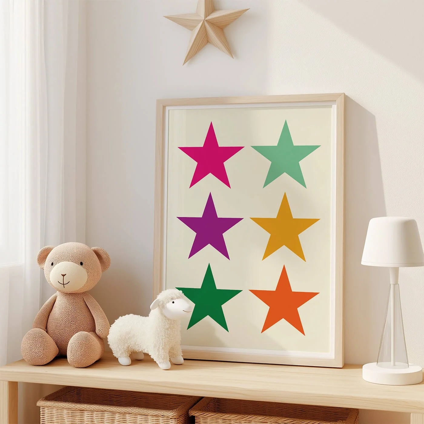Colourful star wall art print displayed in a frame beside neutral children's decor in a modern nursery or kids' bedroom.