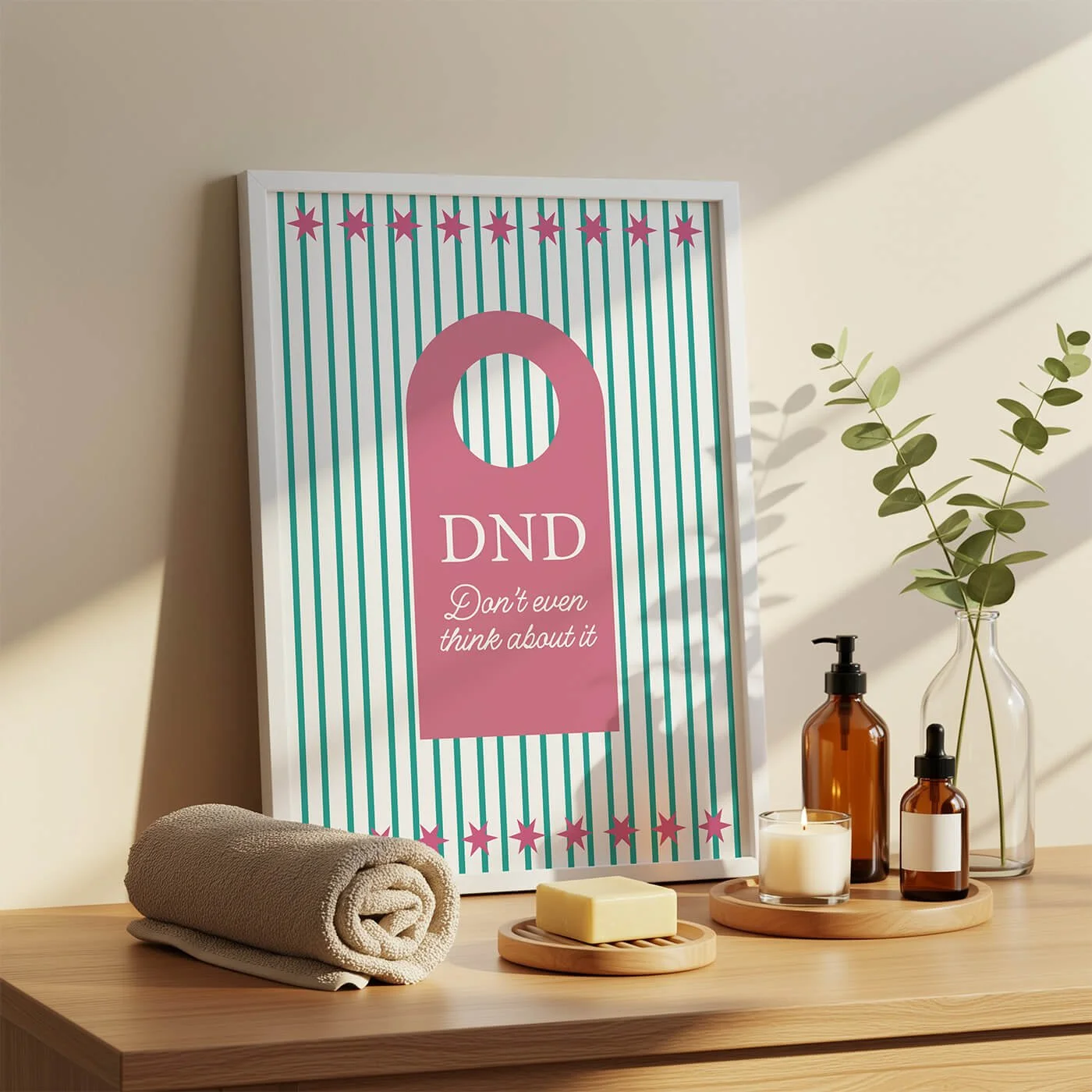 Framed retro-style art print showcasing green vertical stripes and a pink door hanger design with the text DND Don't even think about it